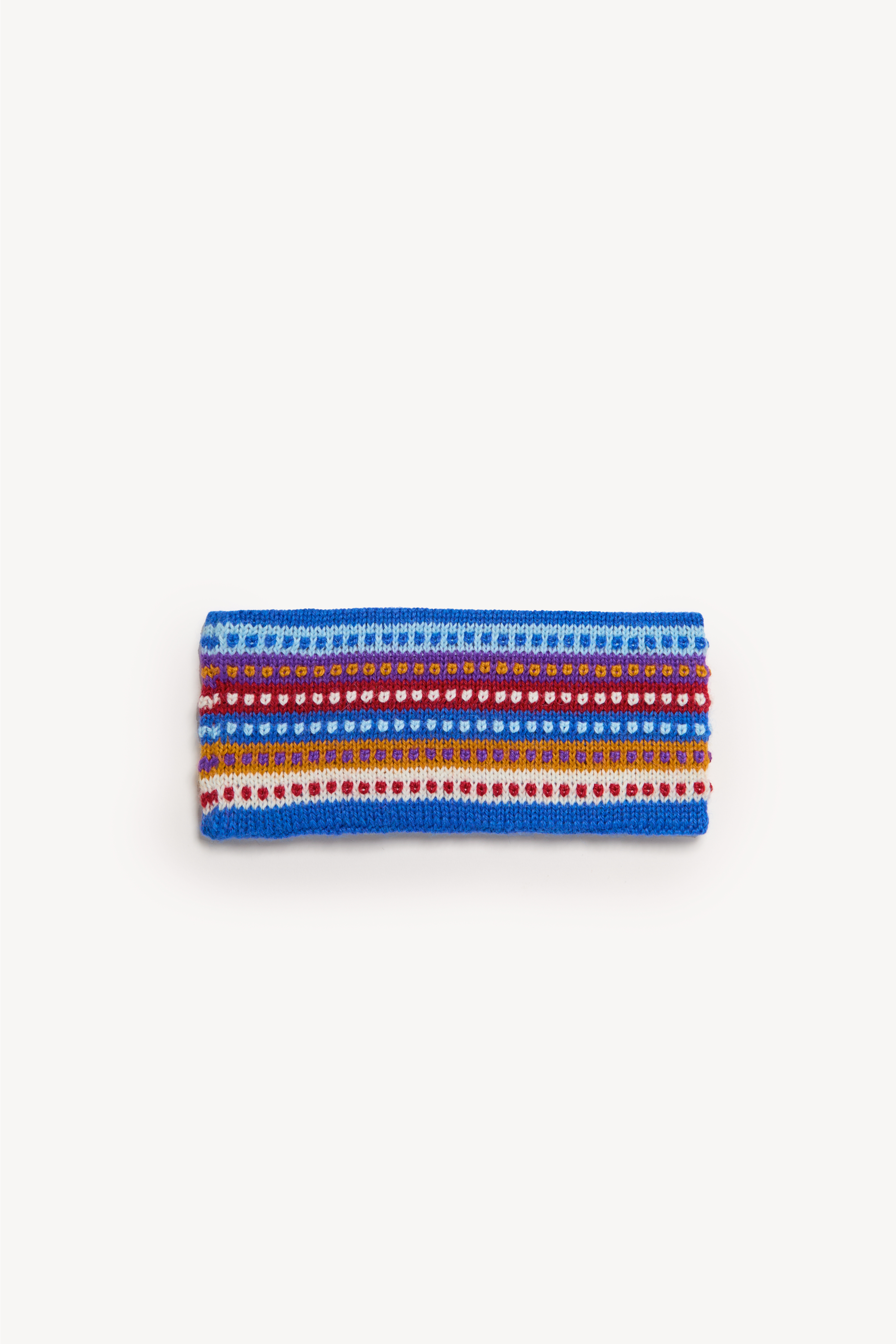Handmade multicolor headbands displayed on a neutral background