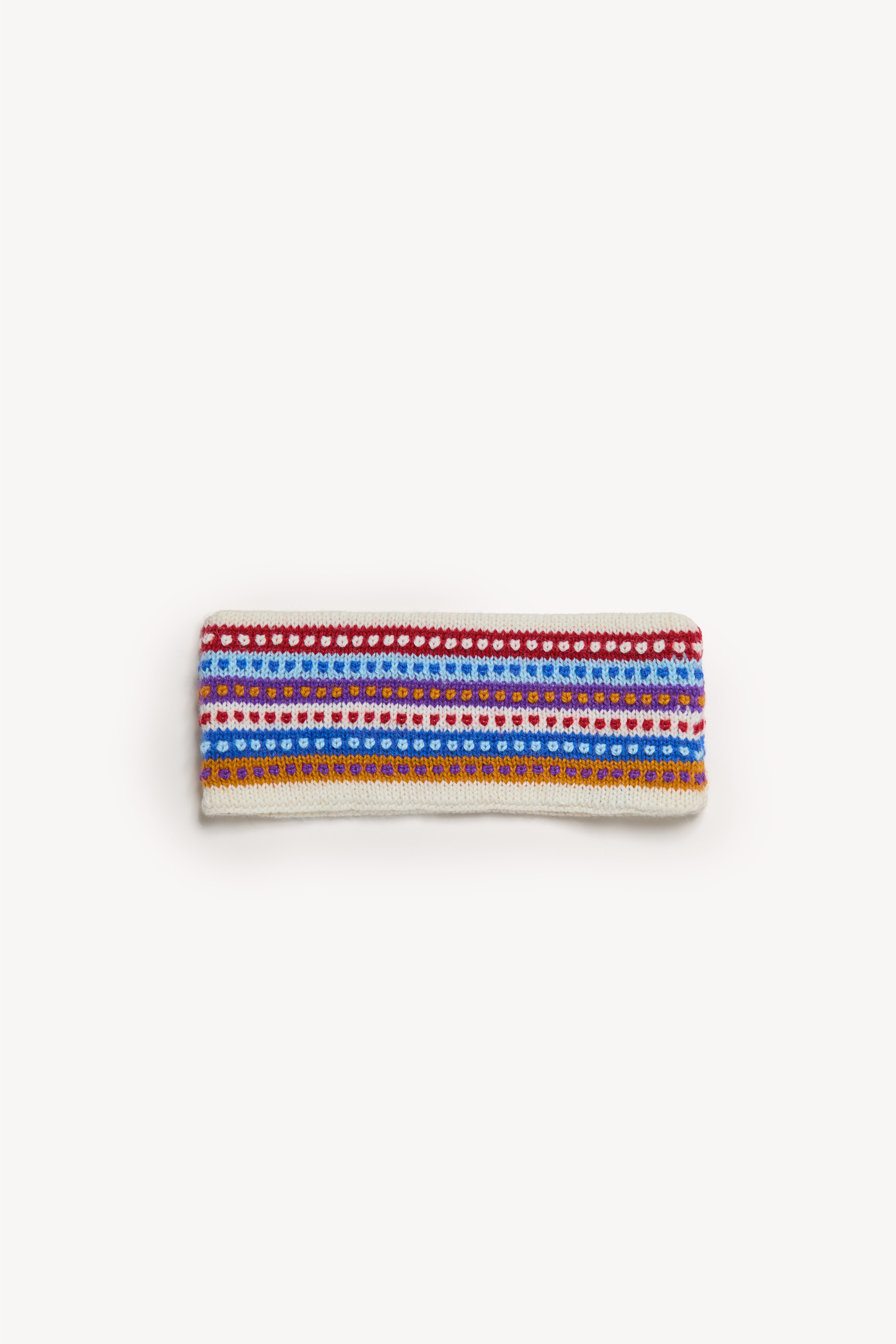 Handmade multicolor headbands displayed on a neutral background