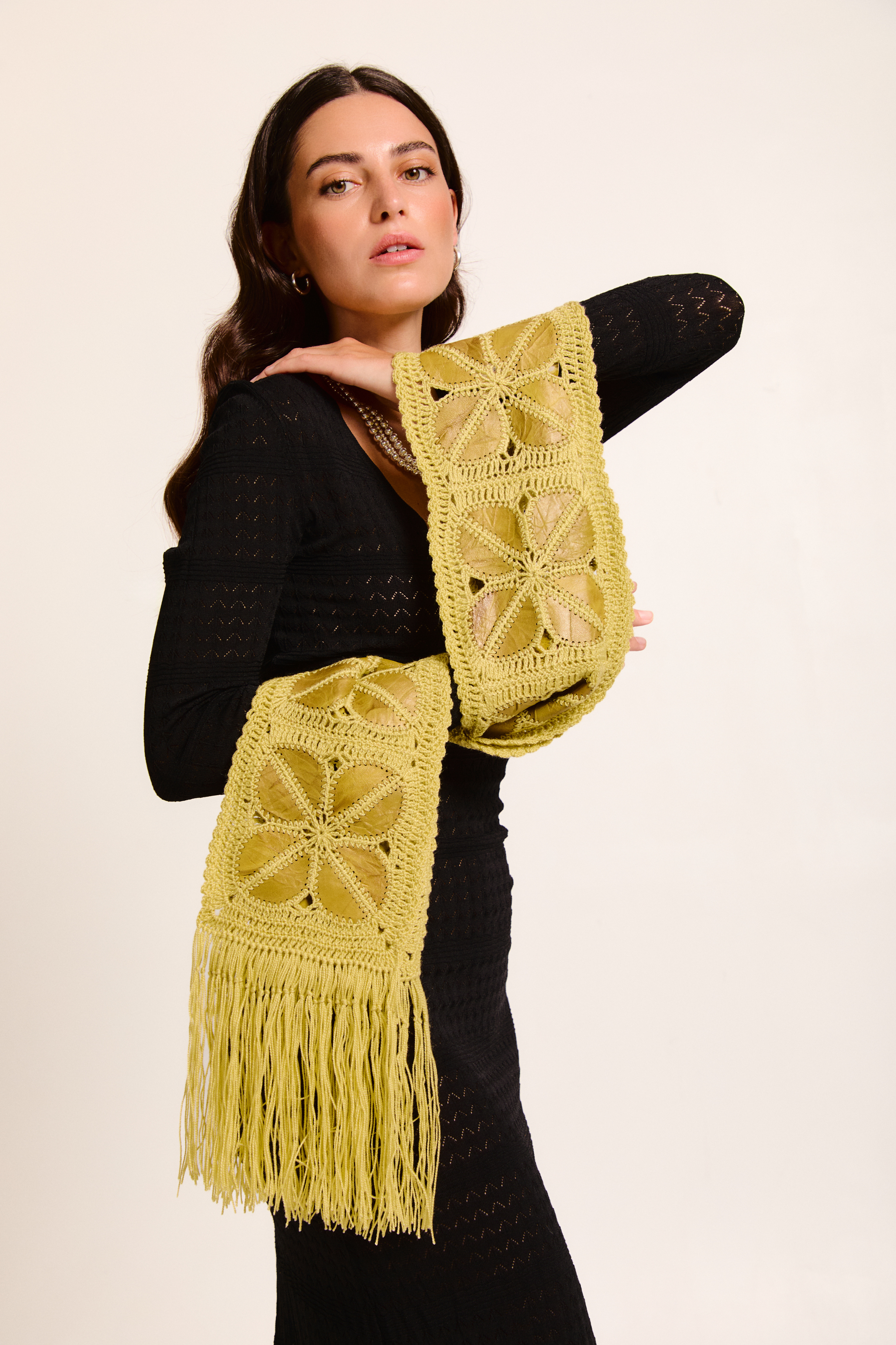 Model wearing a handmade scarf on a neutral background