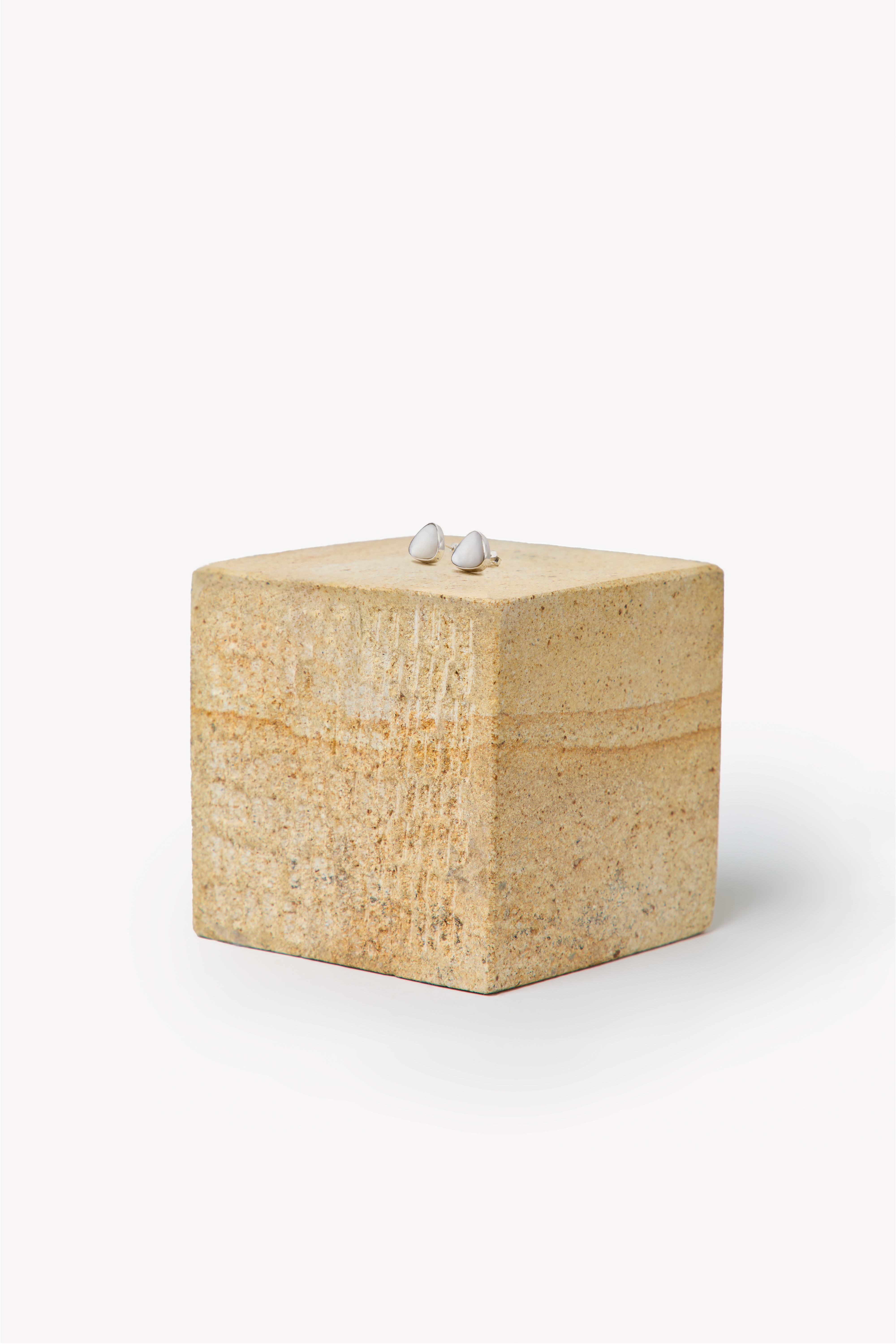 Pair of handmade earrings on a box.