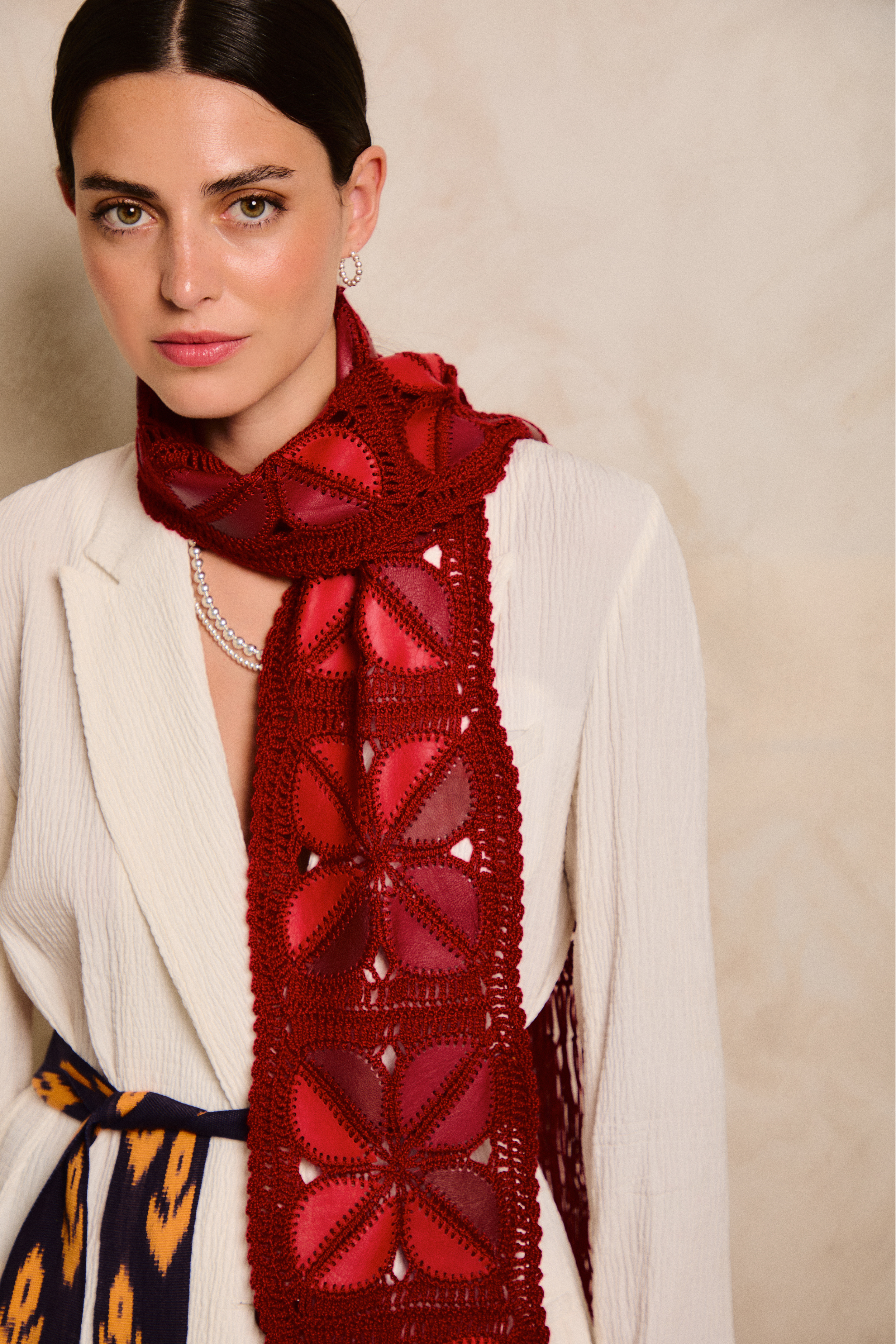 Model wearing a handmade scarf on a neutral background