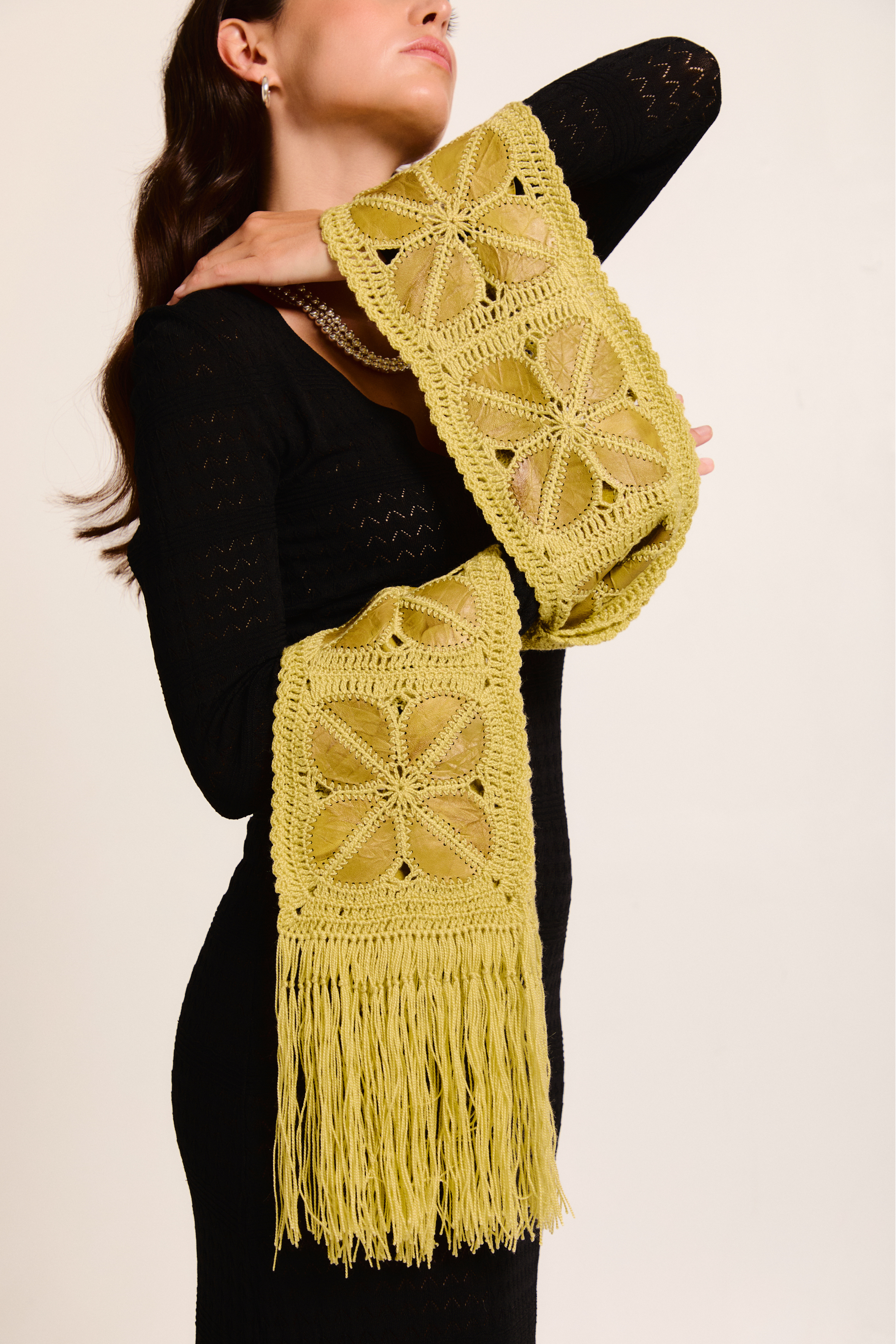 Model wearing a handmade scarf on a neutral background