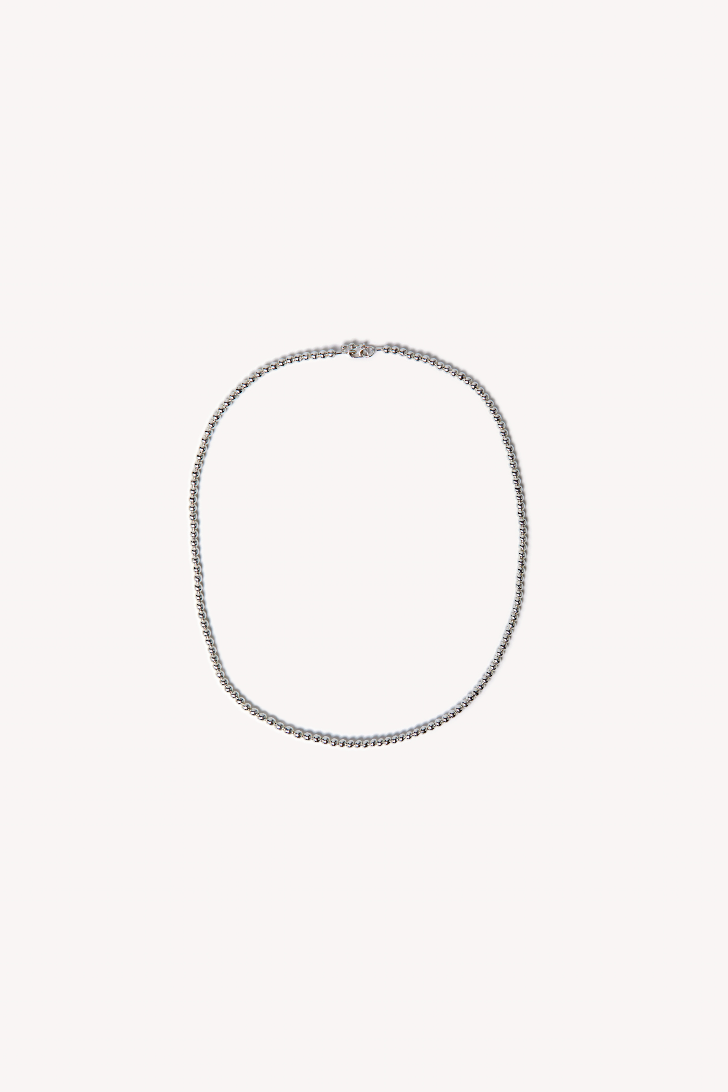 Handmade necklace on a neutral background