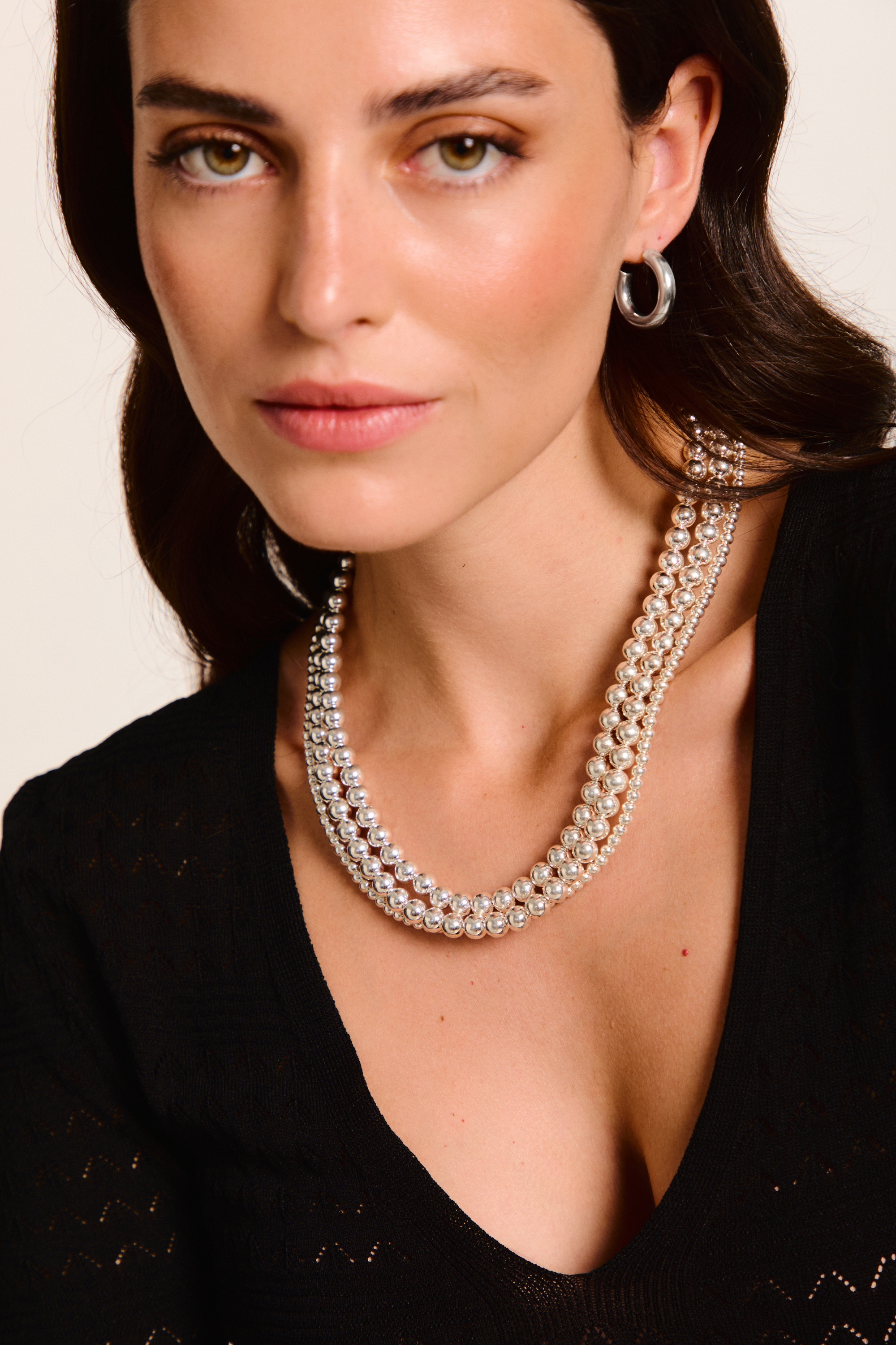 Model wearing one handmade earrings and a three necklaces.