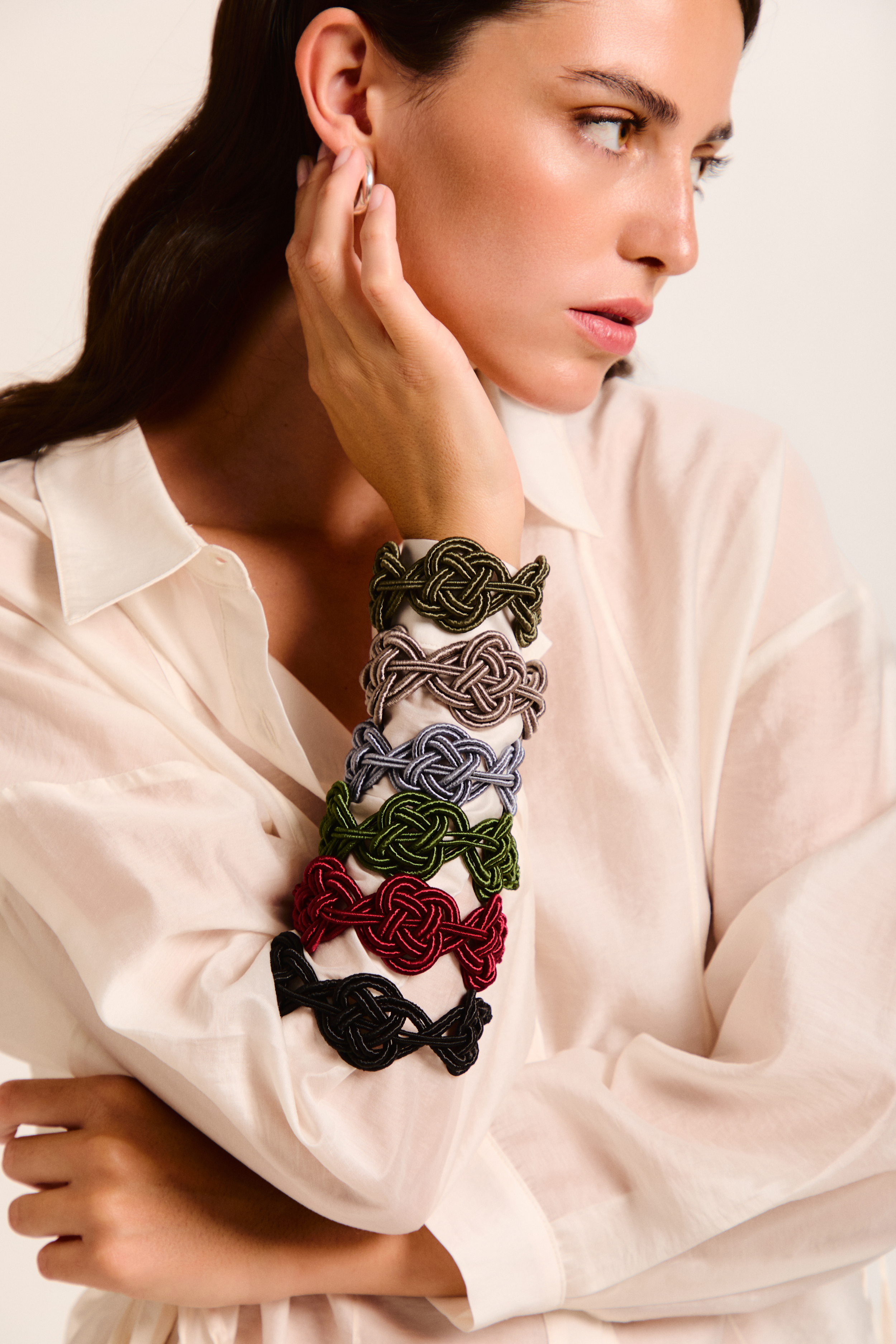 Model showcasing several handmade Nouba bracelets on her arm