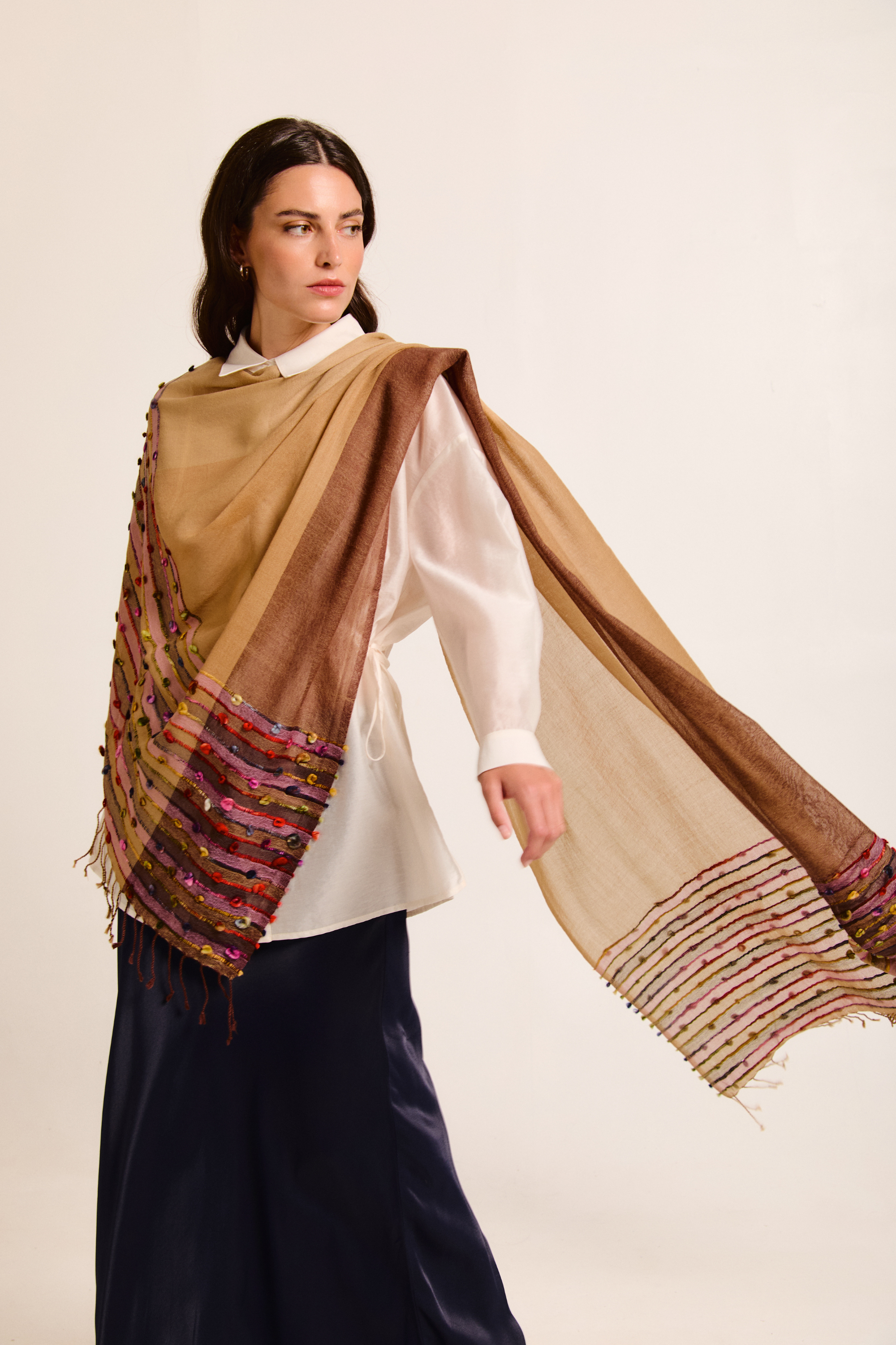 Model showcasing a handmade scarf on a neutral background.