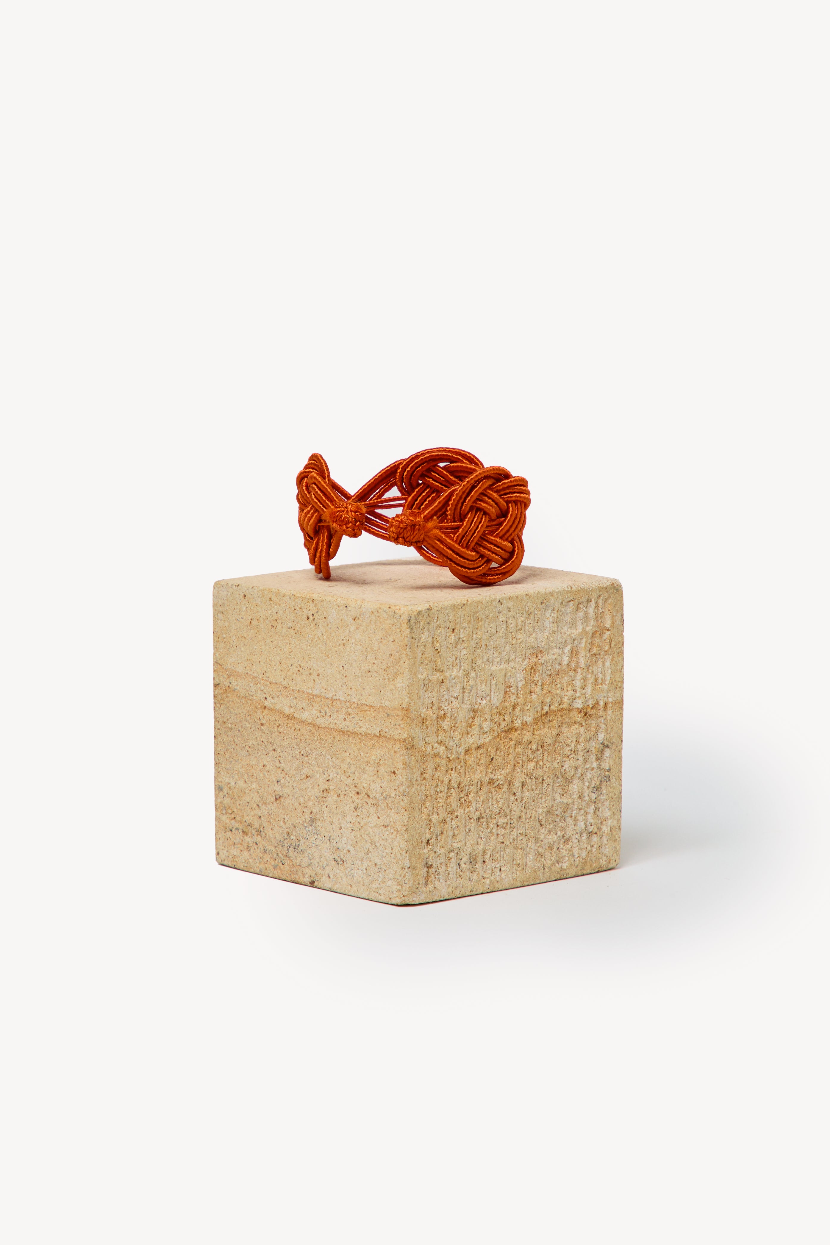 Handmade Nouba bracelet on a box with a neutral background.