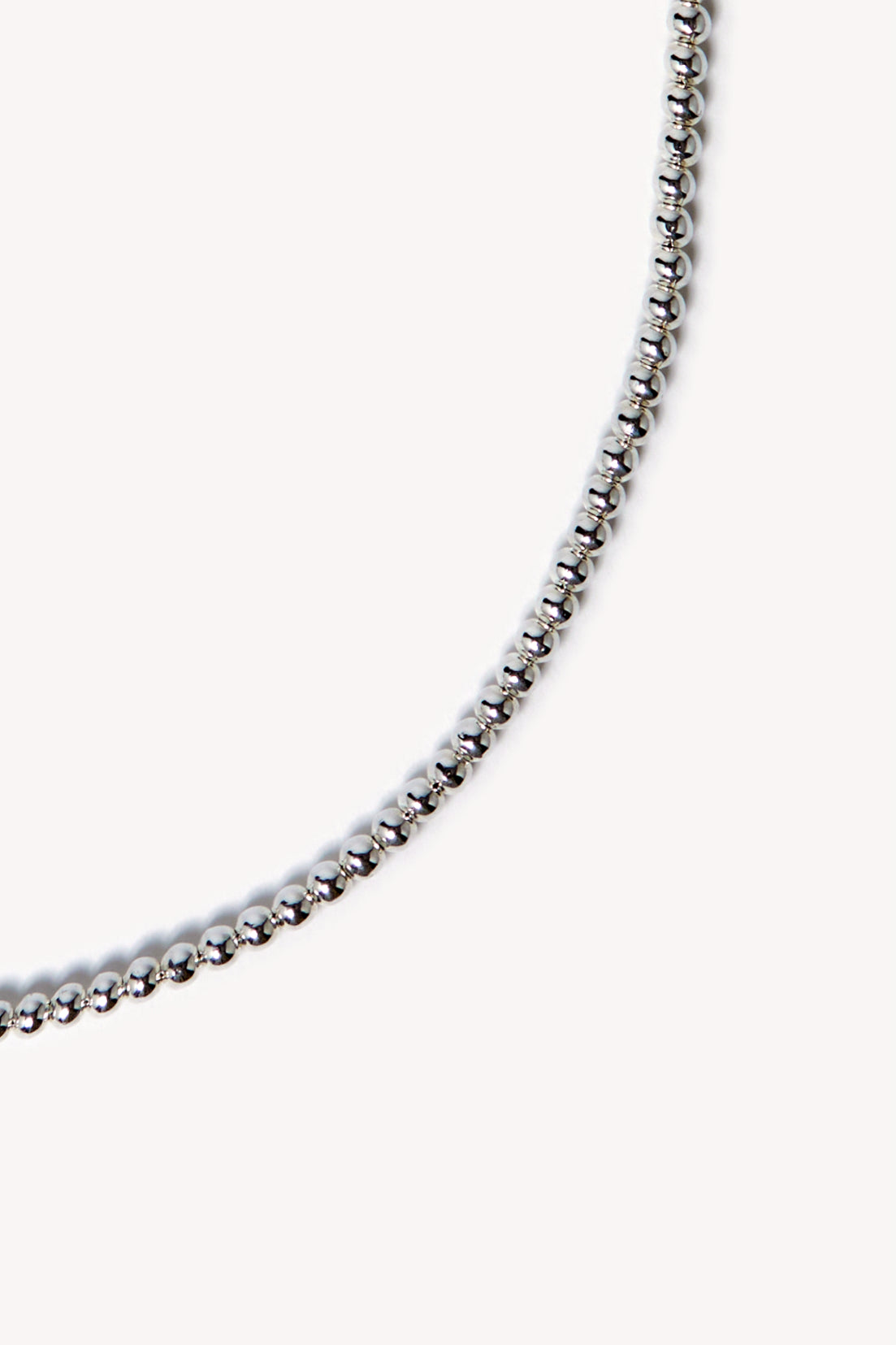 Zoom of a handmade necklace on a neutral background