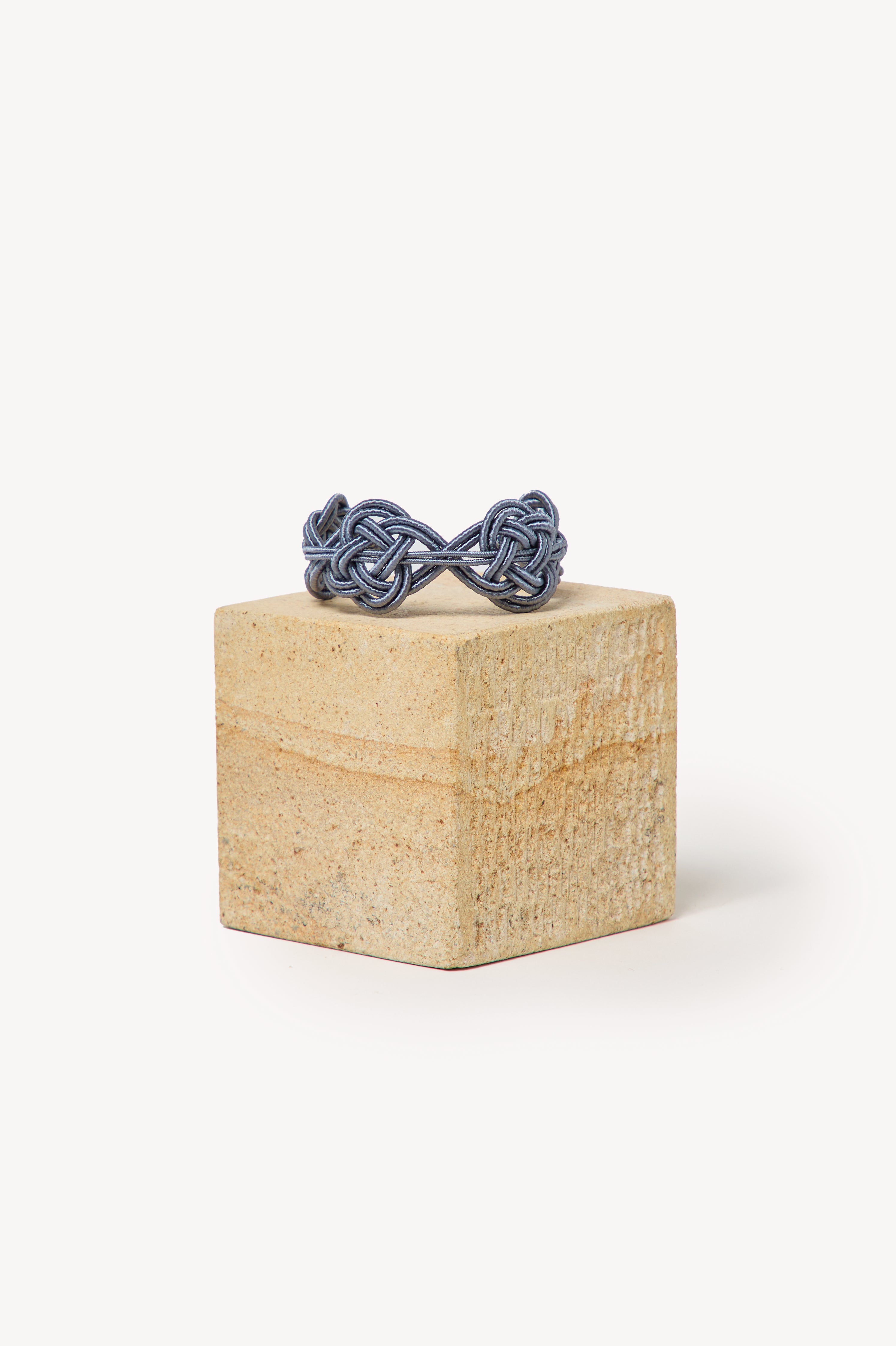 Handmade Nouba bracelet on a box with a neutral background.