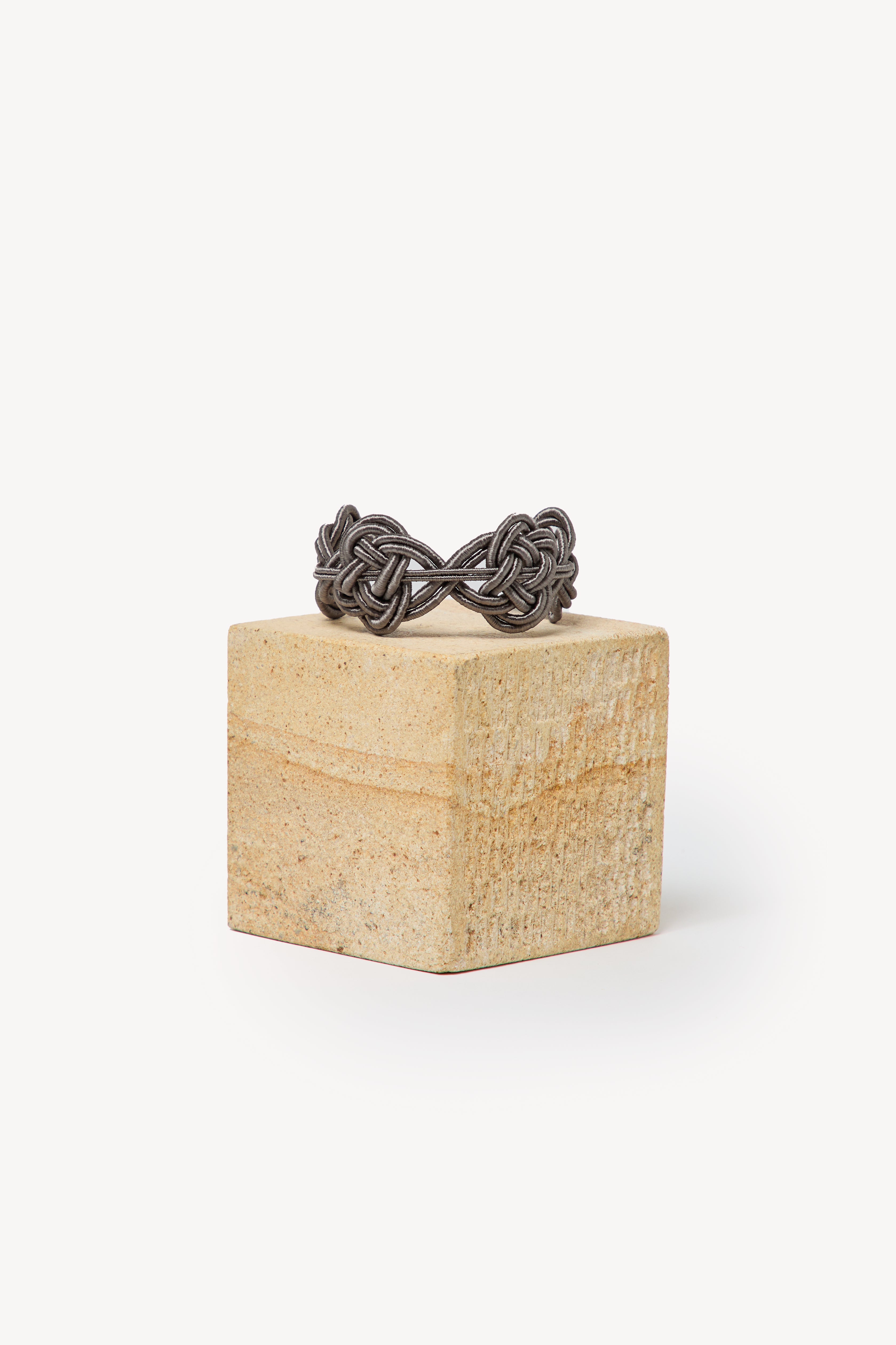 Handmade Nouba bracelet on a box with a neutral background.