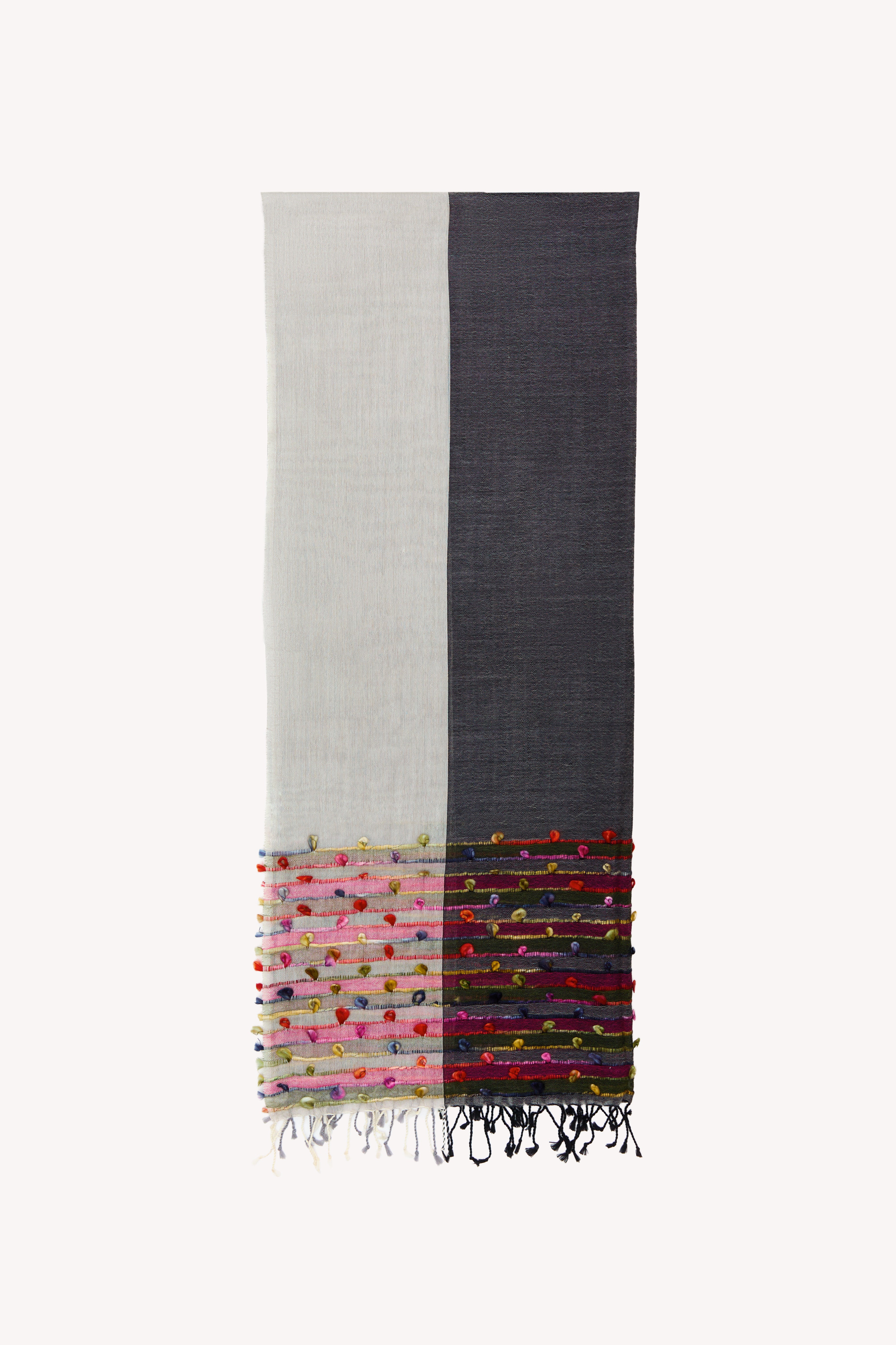 Grey handcrafted scarf on a neutral background.