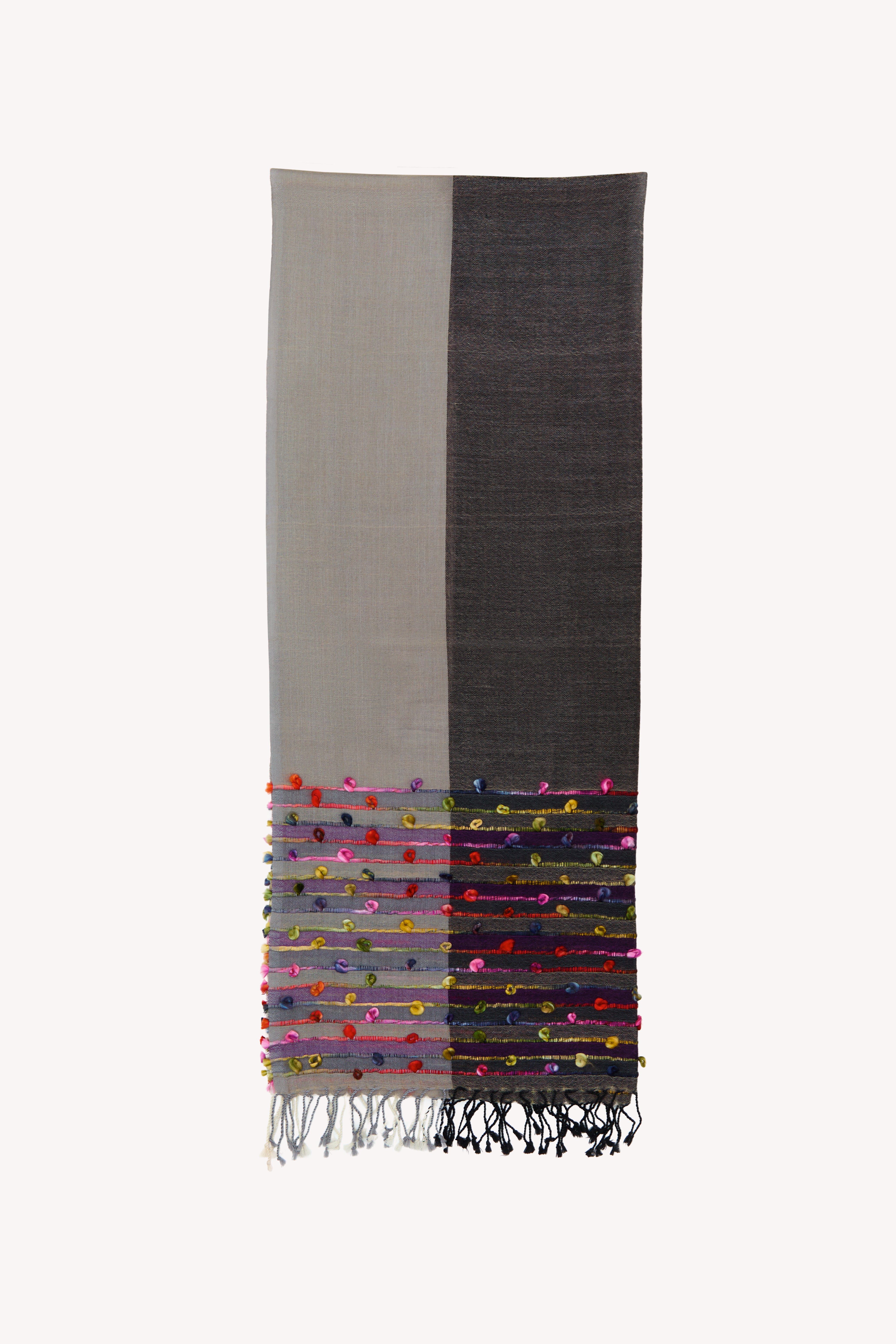 Colorful handcrafted scarf on a neutral background.