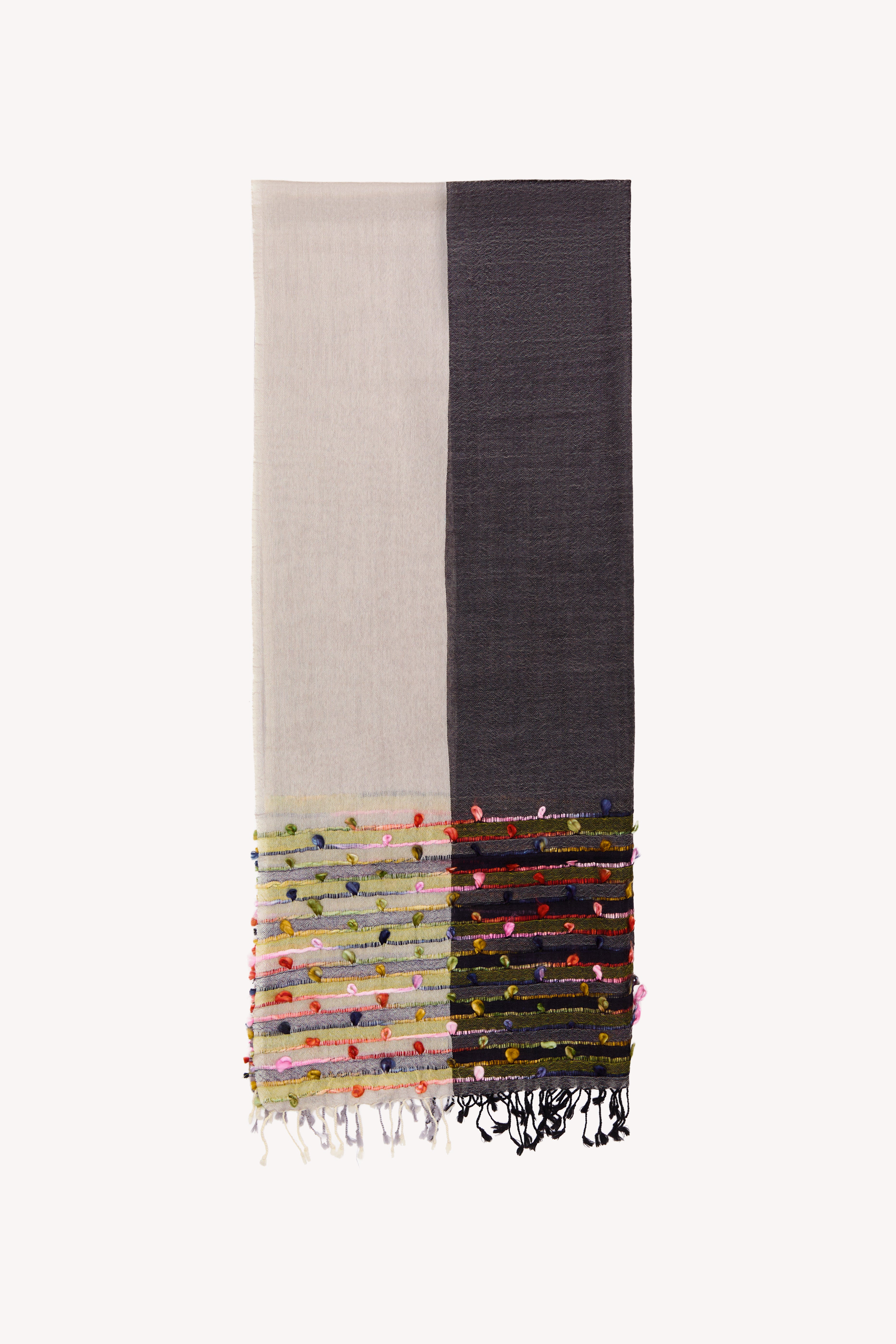 Grey handcrafted scarf on a neutral background.