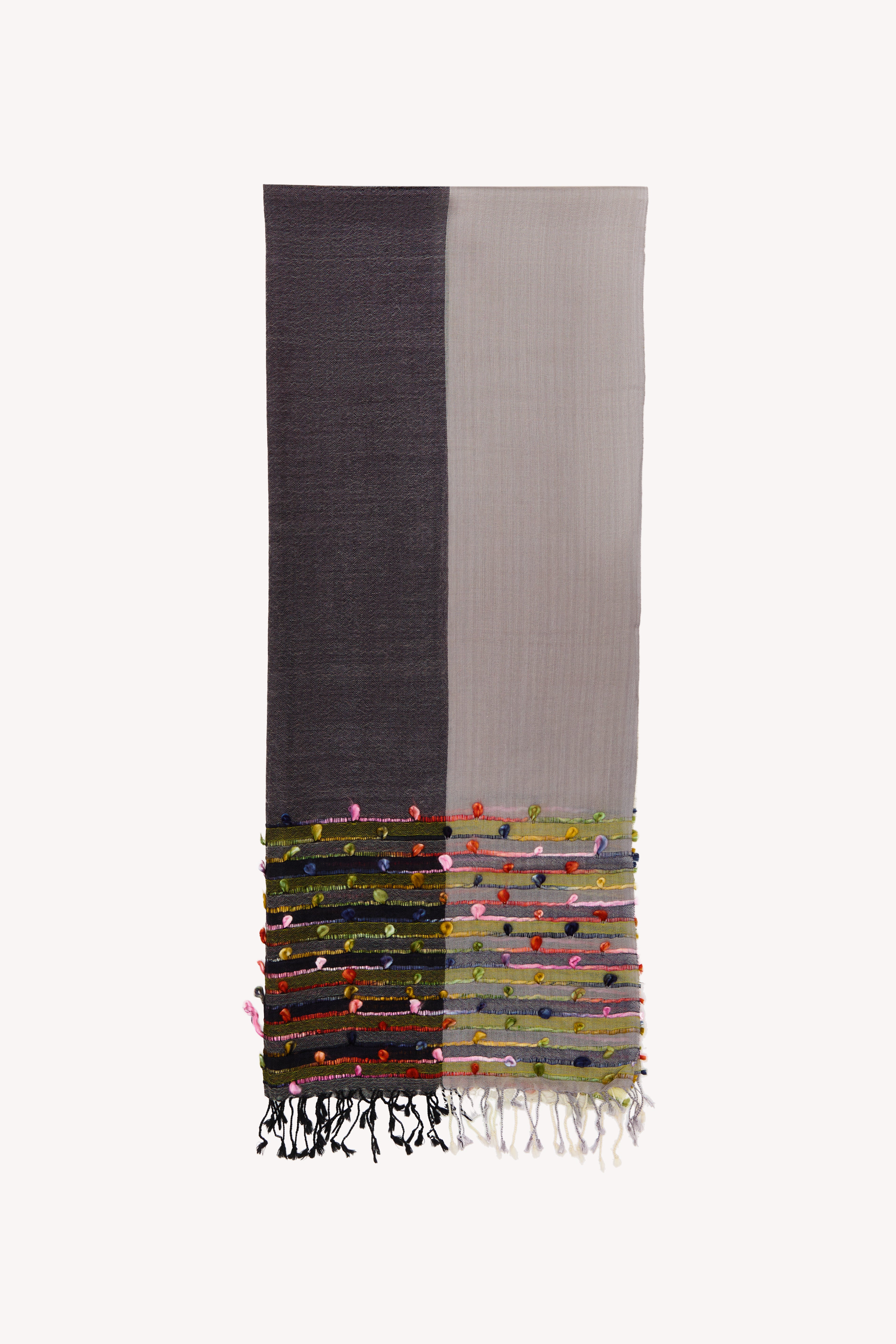 Grey handcrafted scarf on a neutral background.