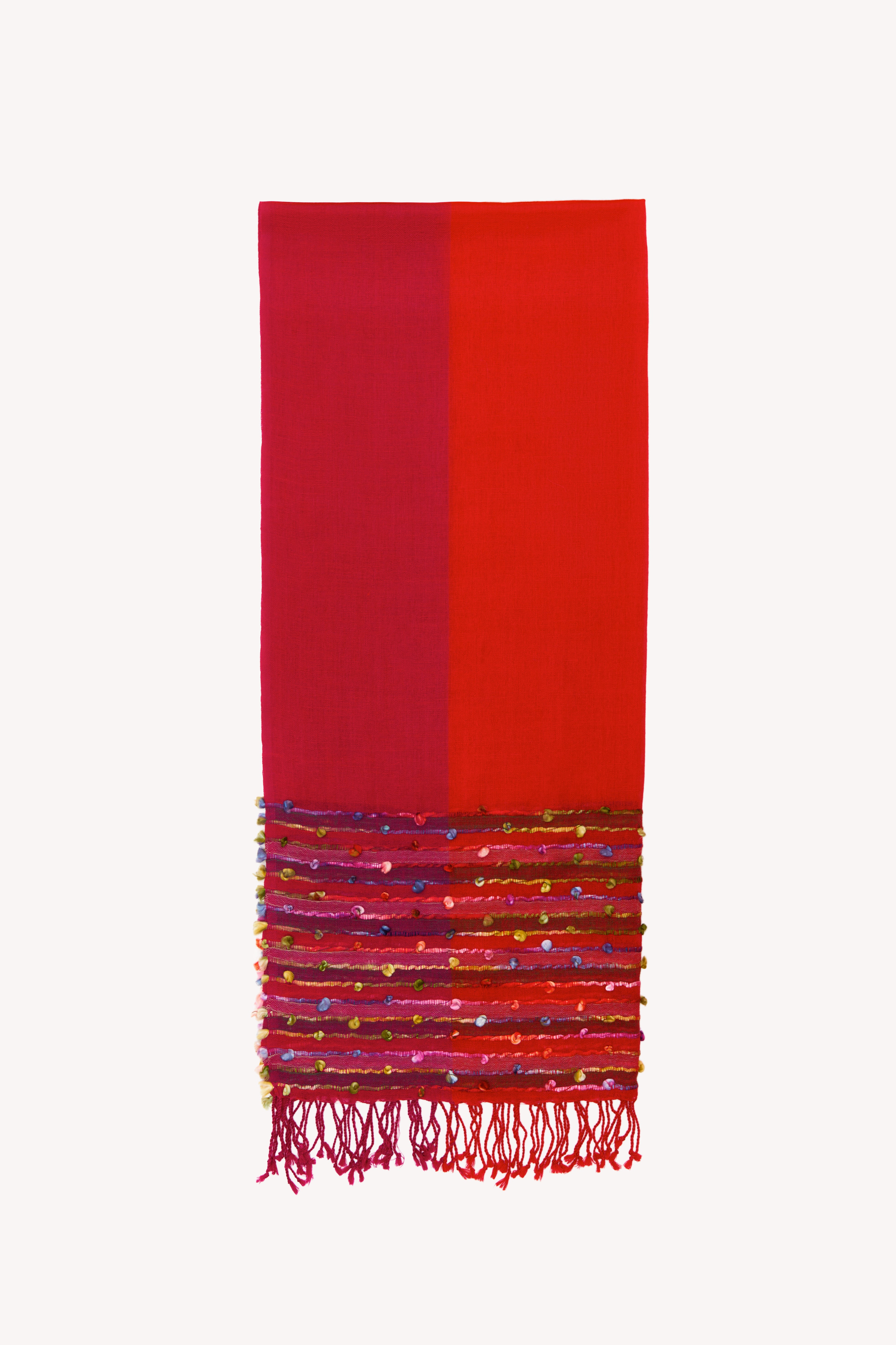 red handcrafted scarf on a neutral background.