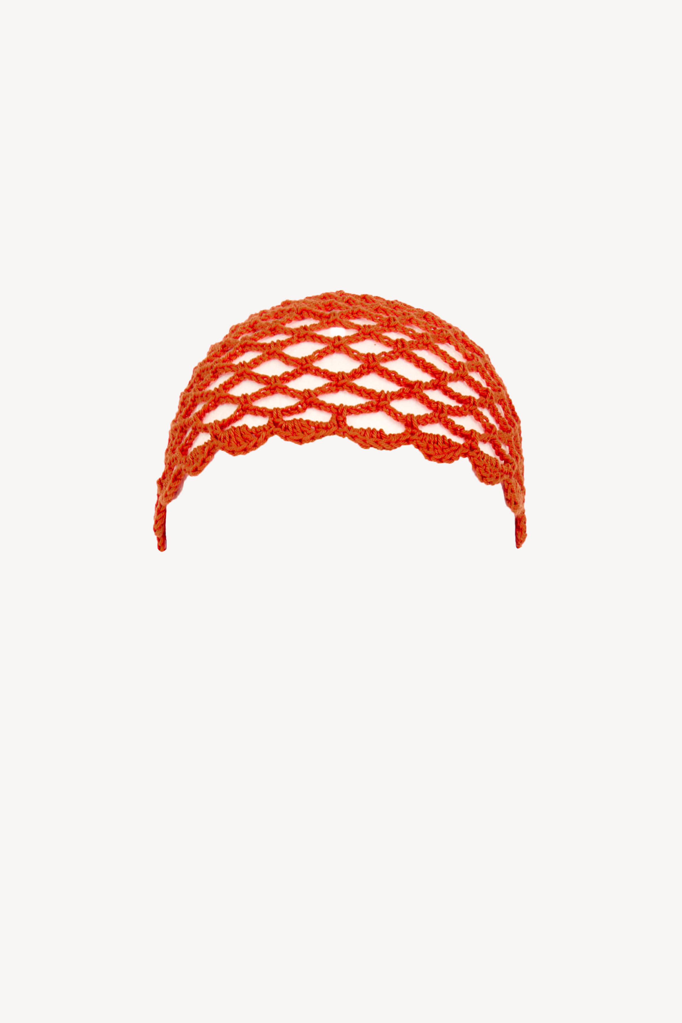 Terracotta cotton crochet cap with open weave, handmade in Ecuador.