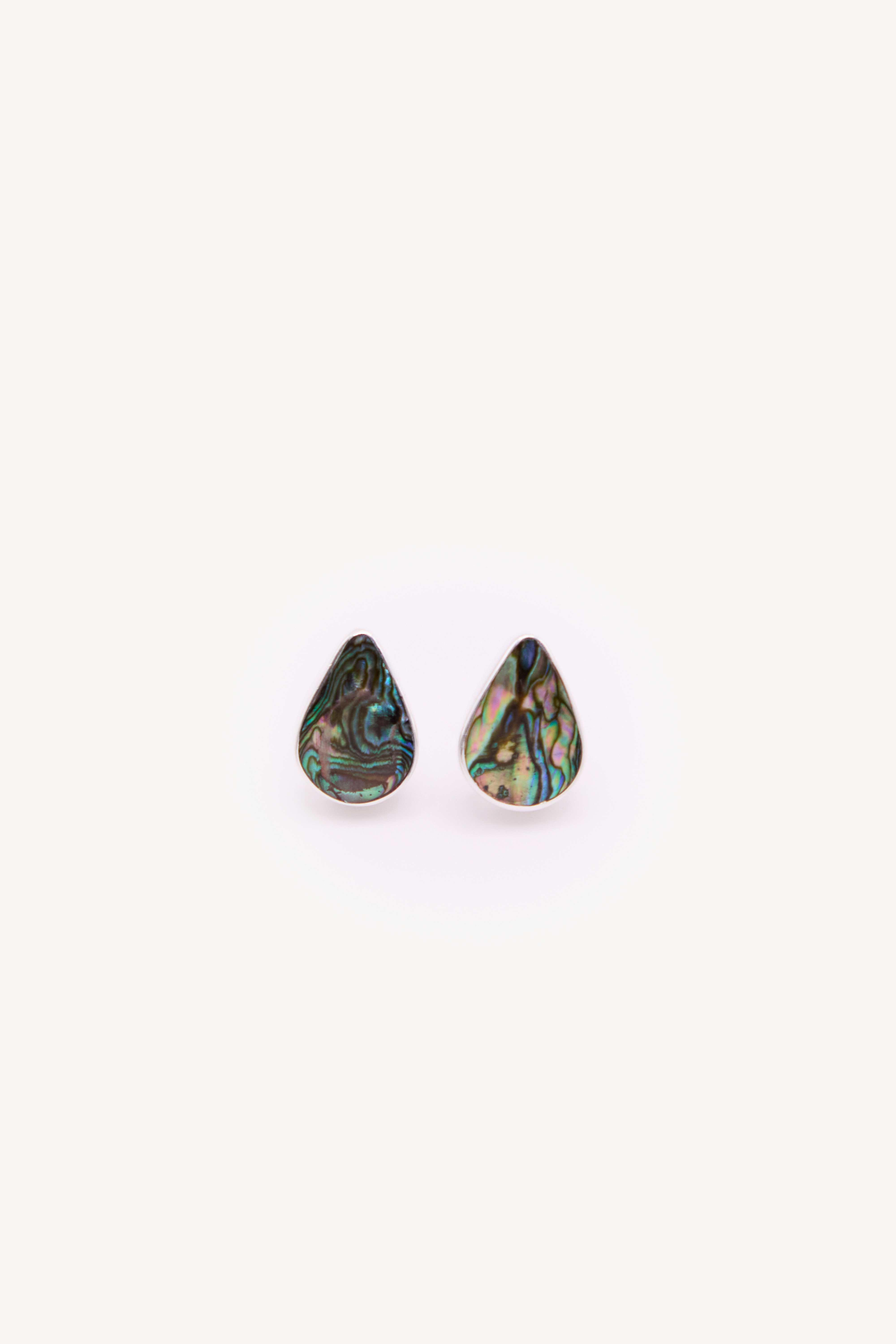 Pair of handmade earrings on a neutral background.