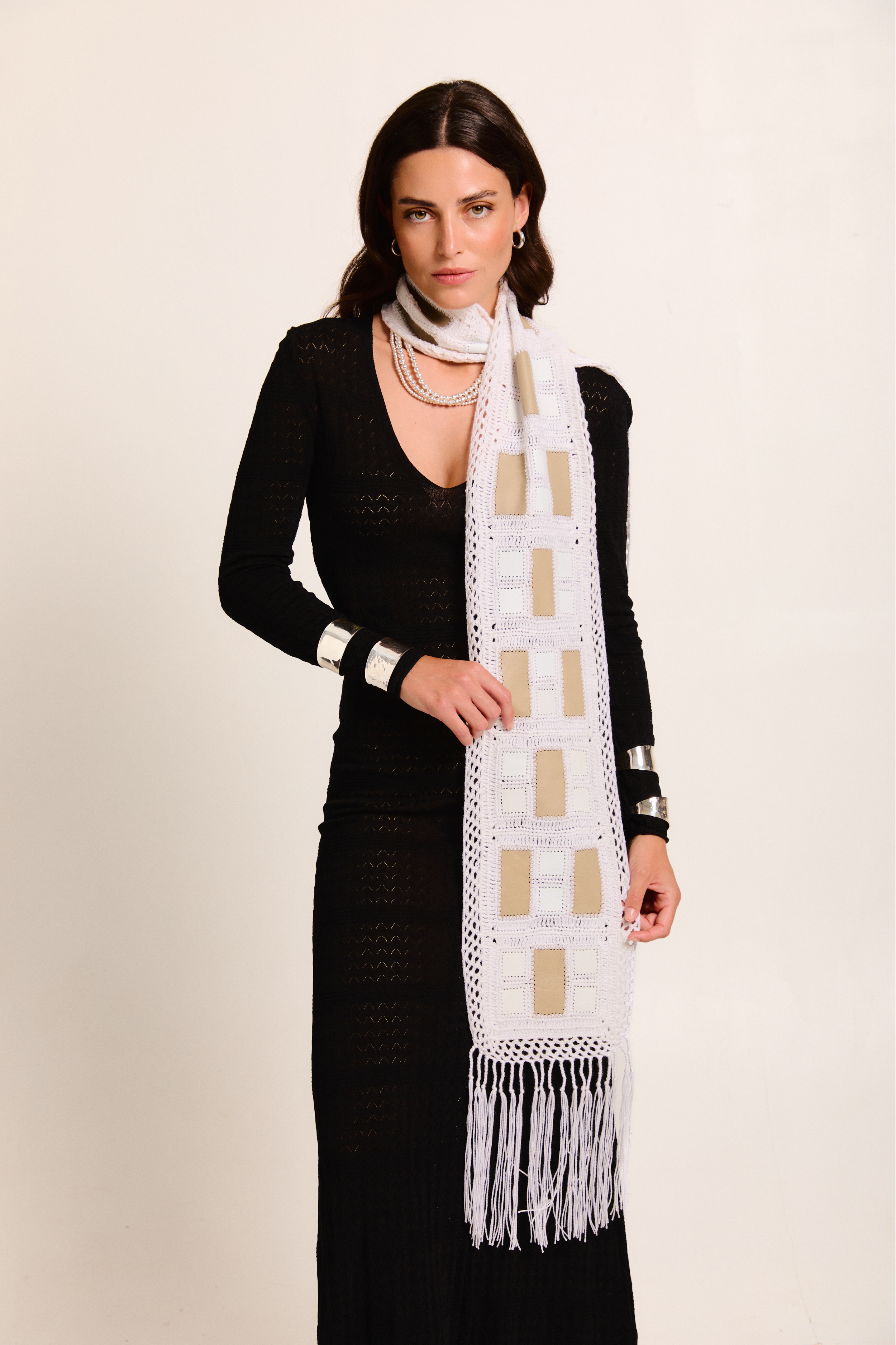 Model wearing a handmade scarf on a neutral background
