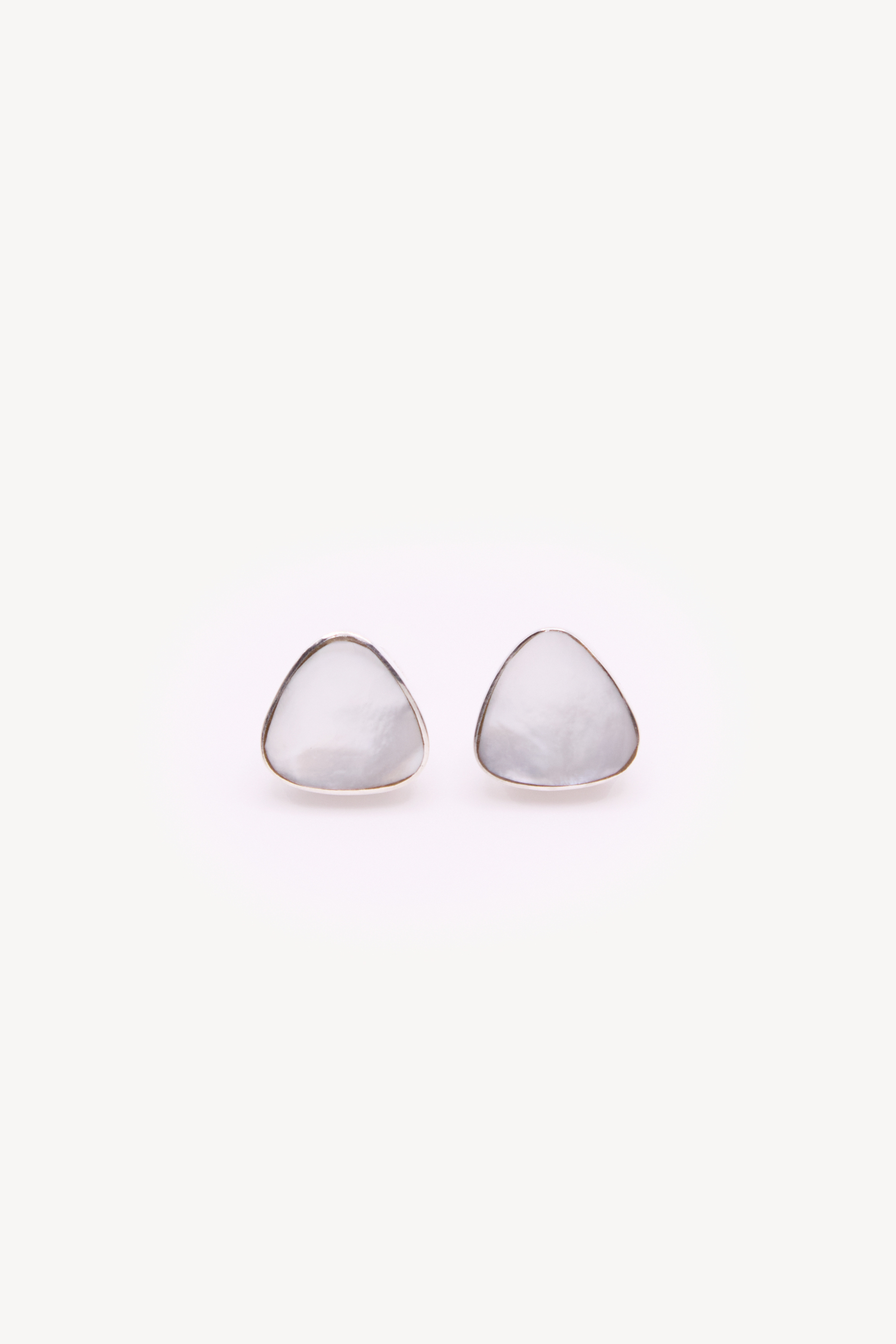 Pair of handmade earrings on a neutral background.