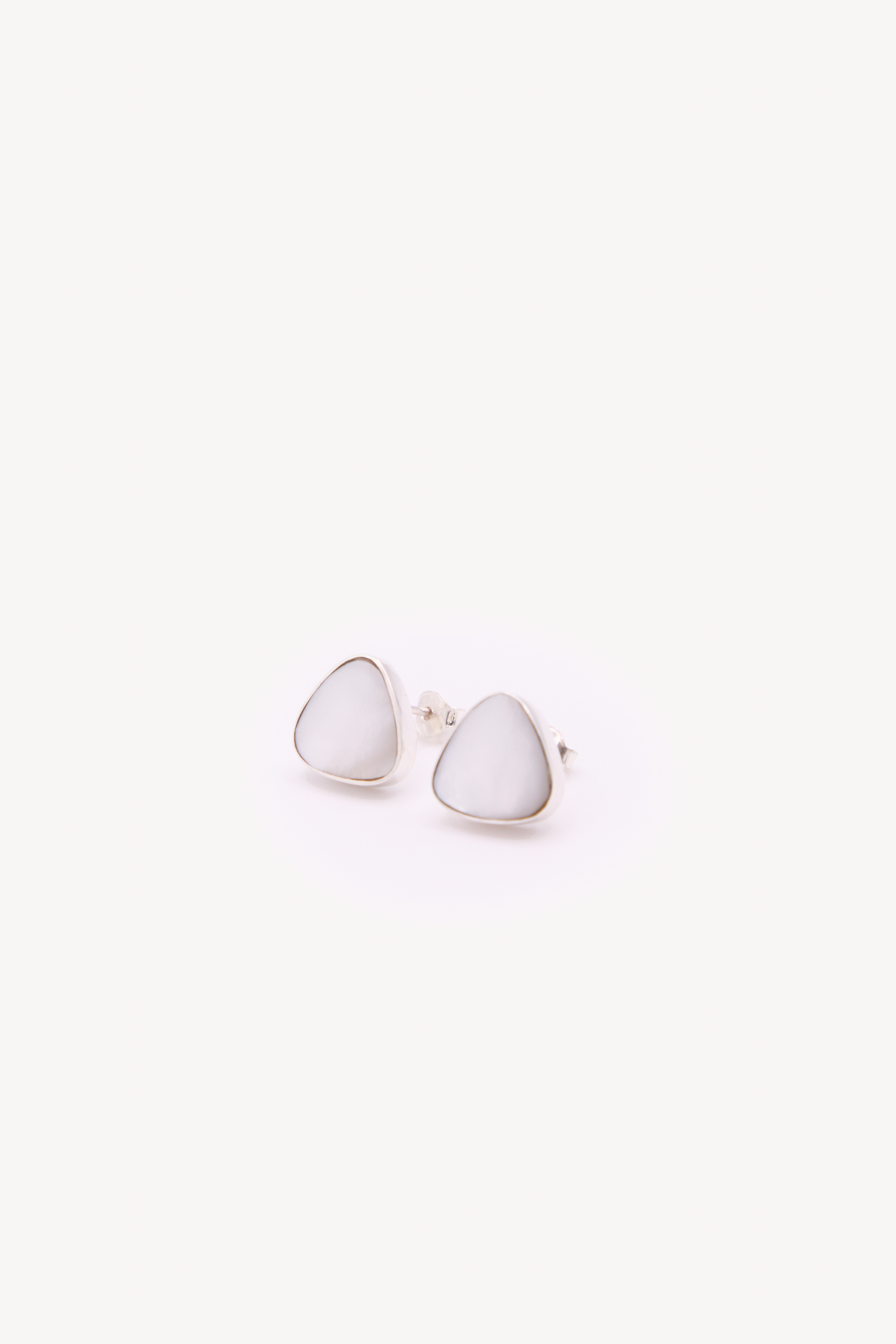 Pair of handmade earrings on a neutral background.