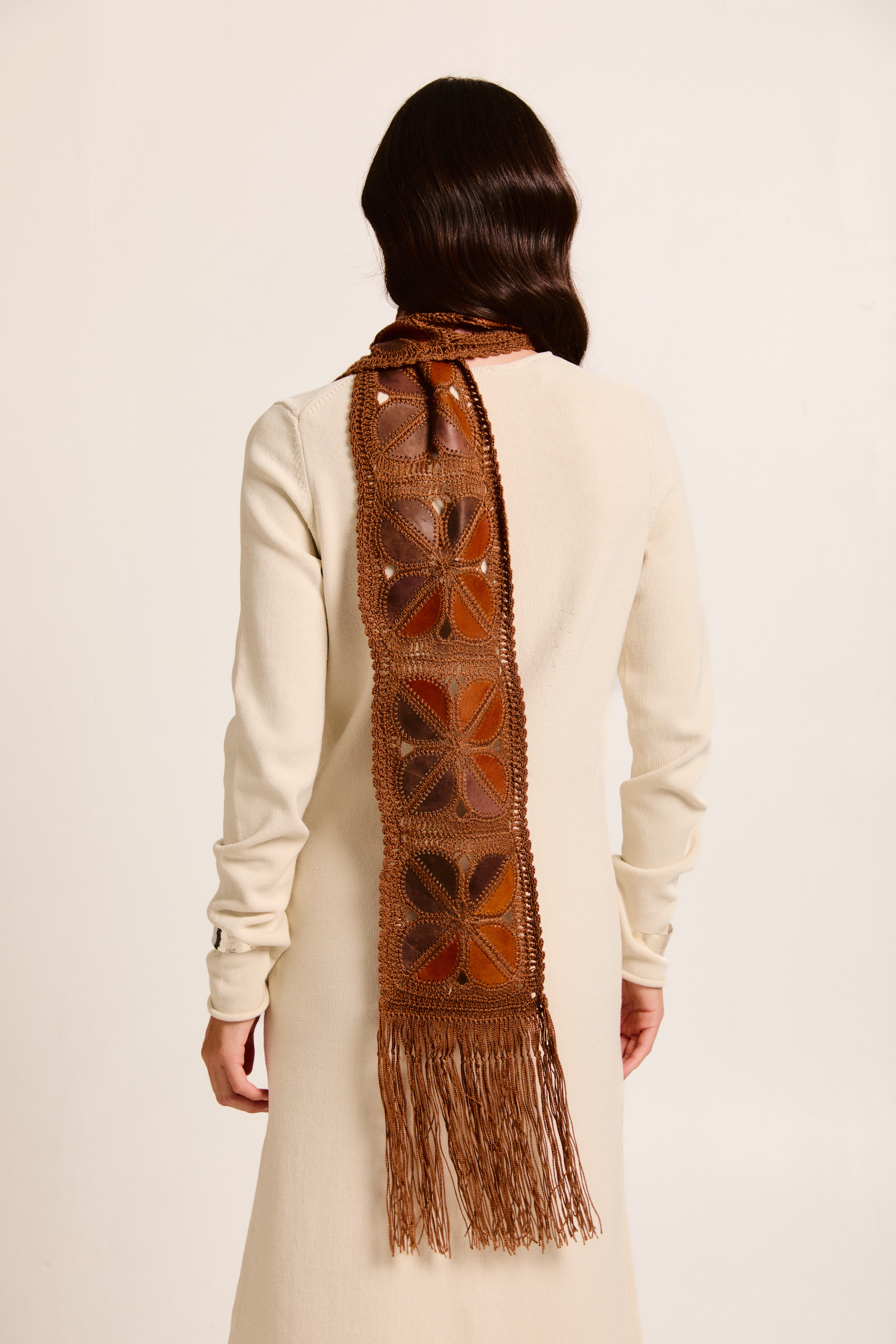 Model wearing a handmade scarf on a neutral background