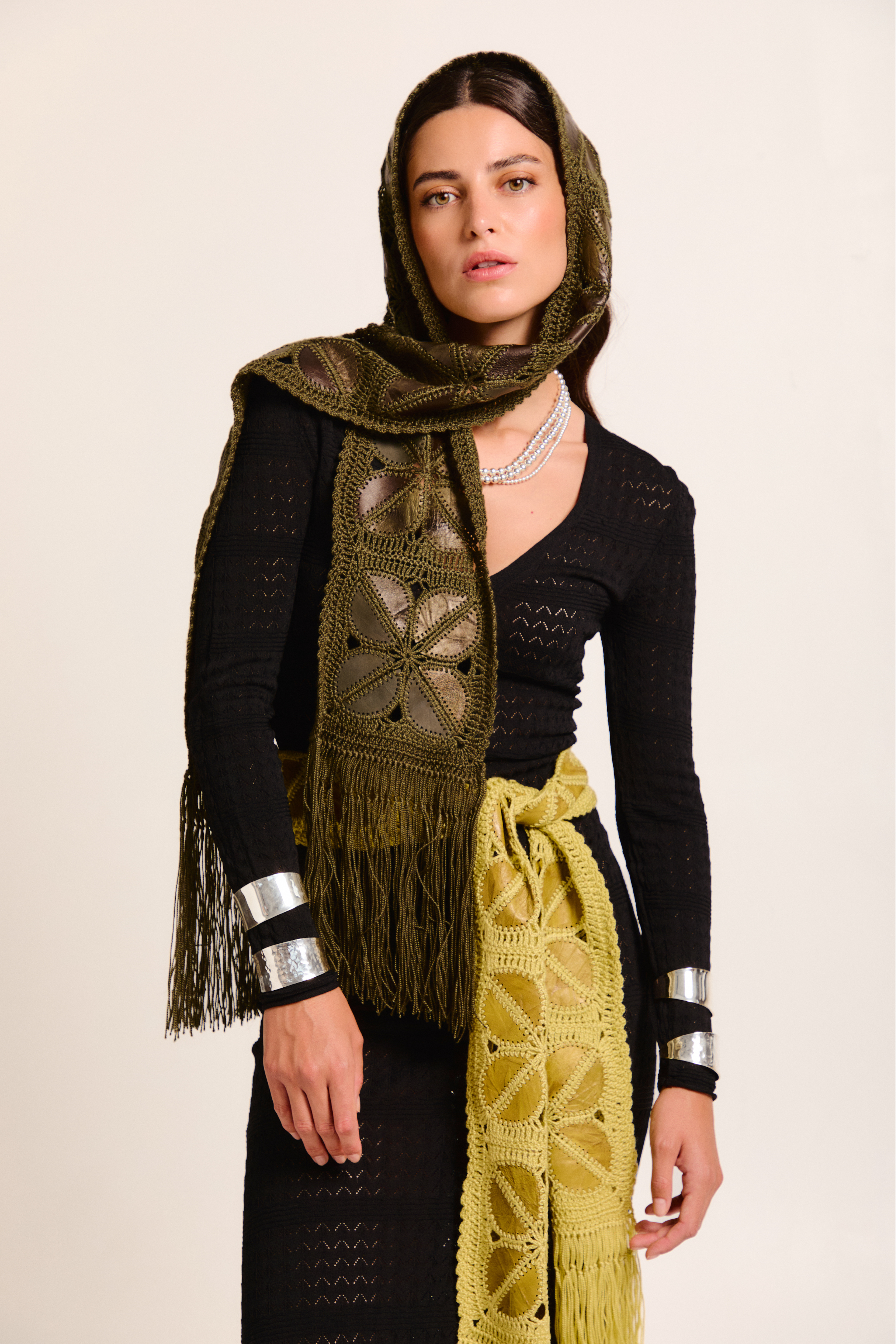 Model wearing a two handmade scarves on a neutral background