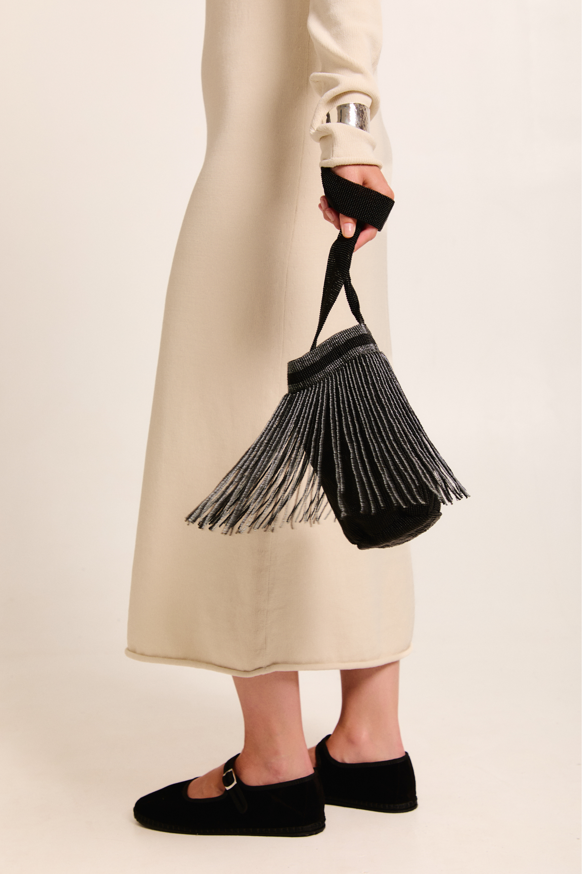 Model holding a Betsá Fringe Mochila Bag on a neutral background.
