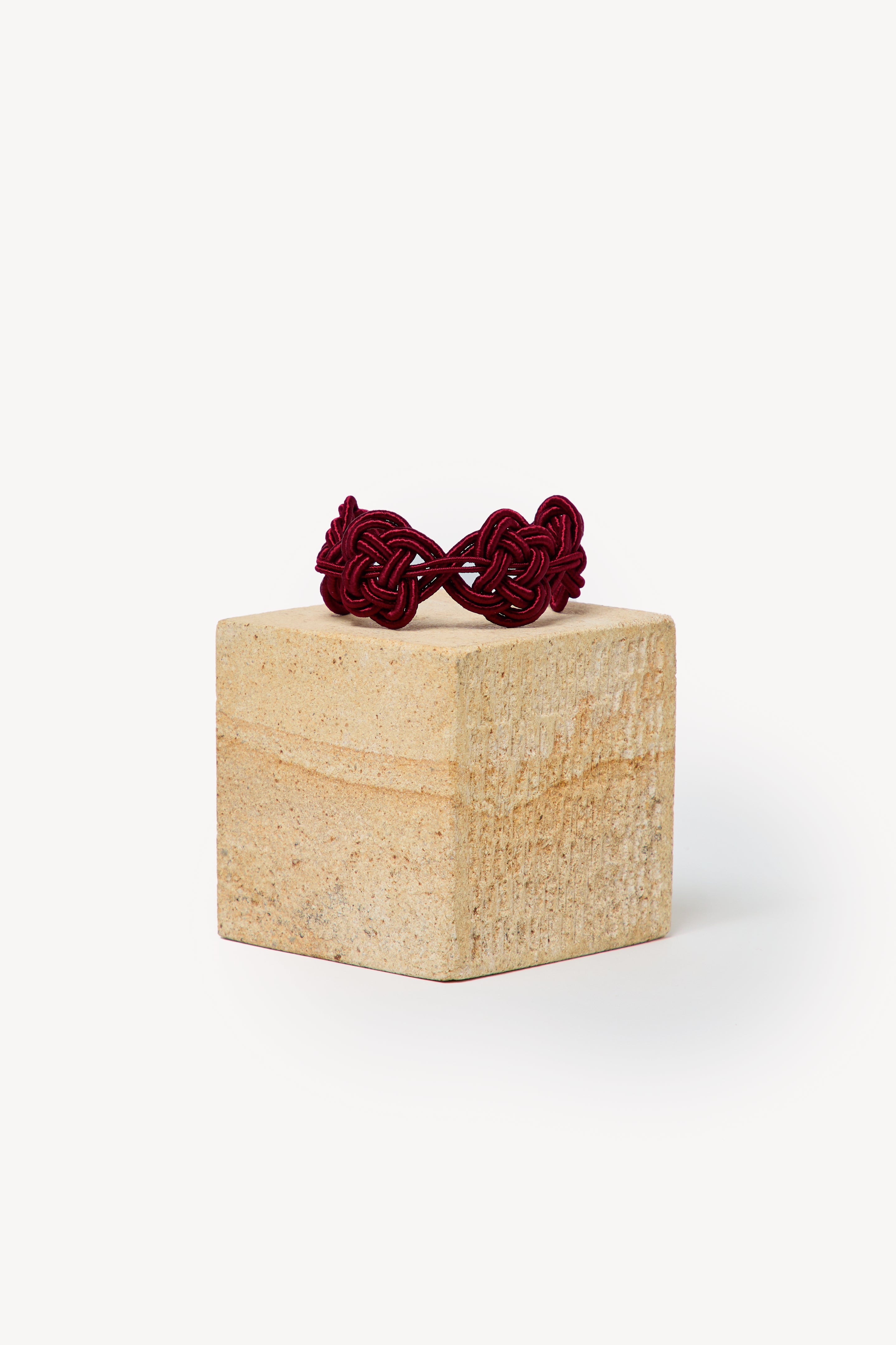 Handmade Nouba bracelet on a box with a neutral background.