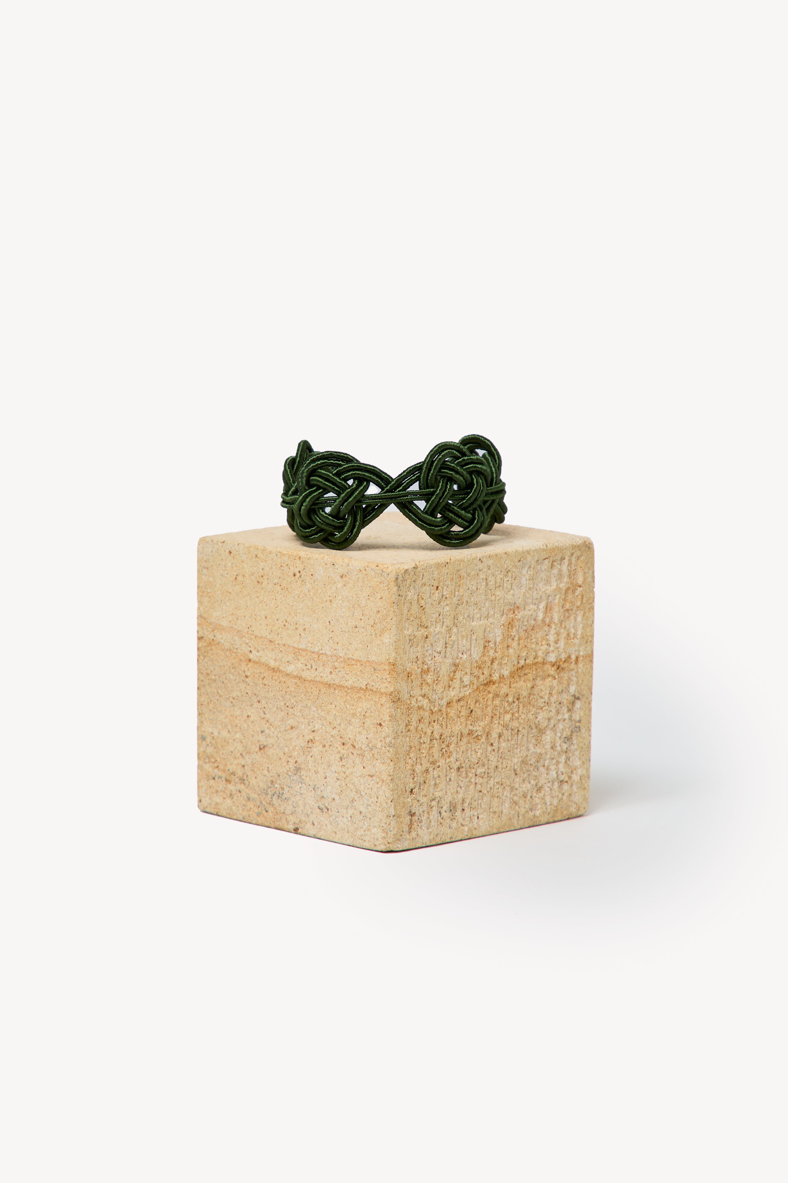 Handmade Nouba bracelet on a box with a neutral background.