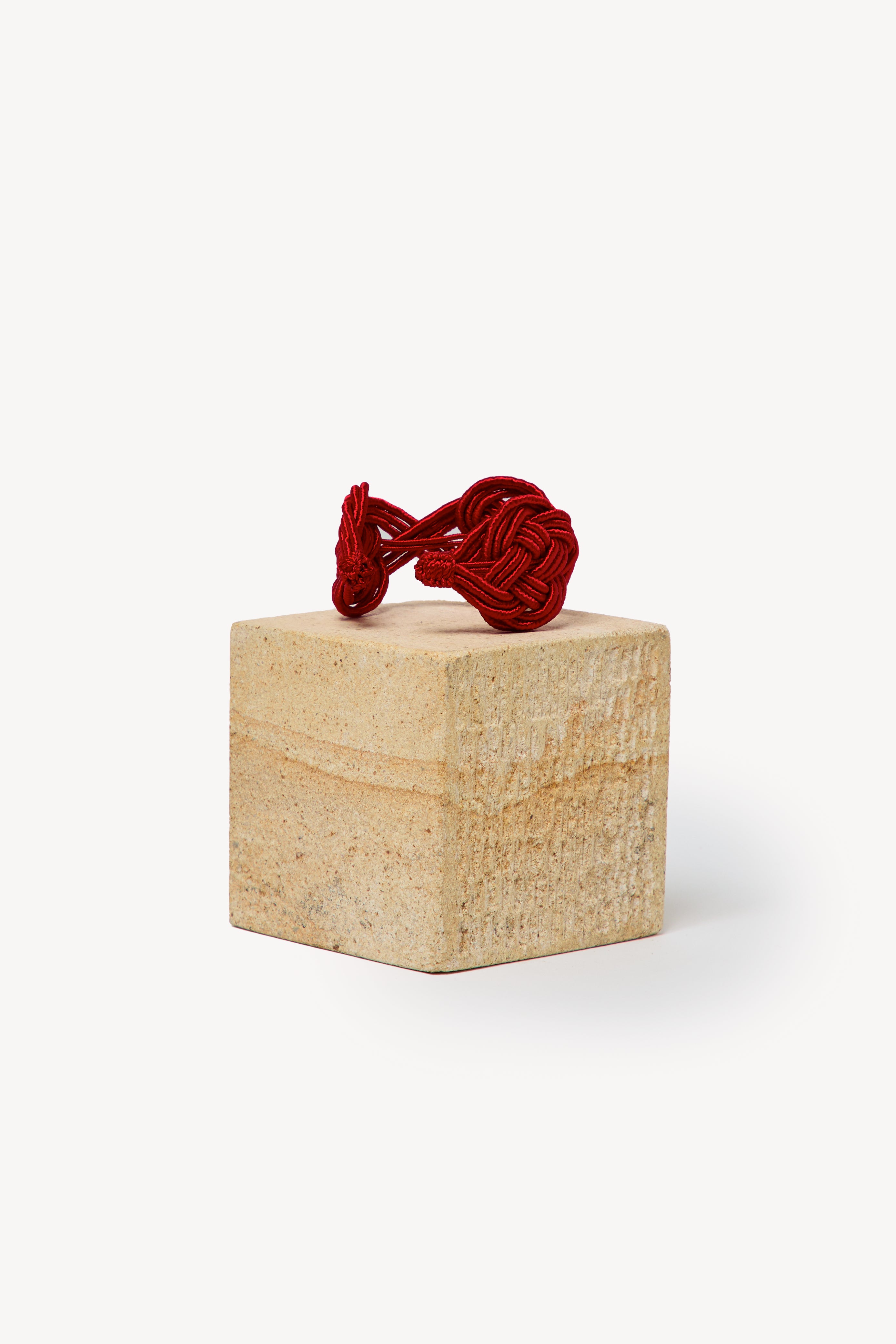 Handmade Nouba bracelet on a box with a neutral background.