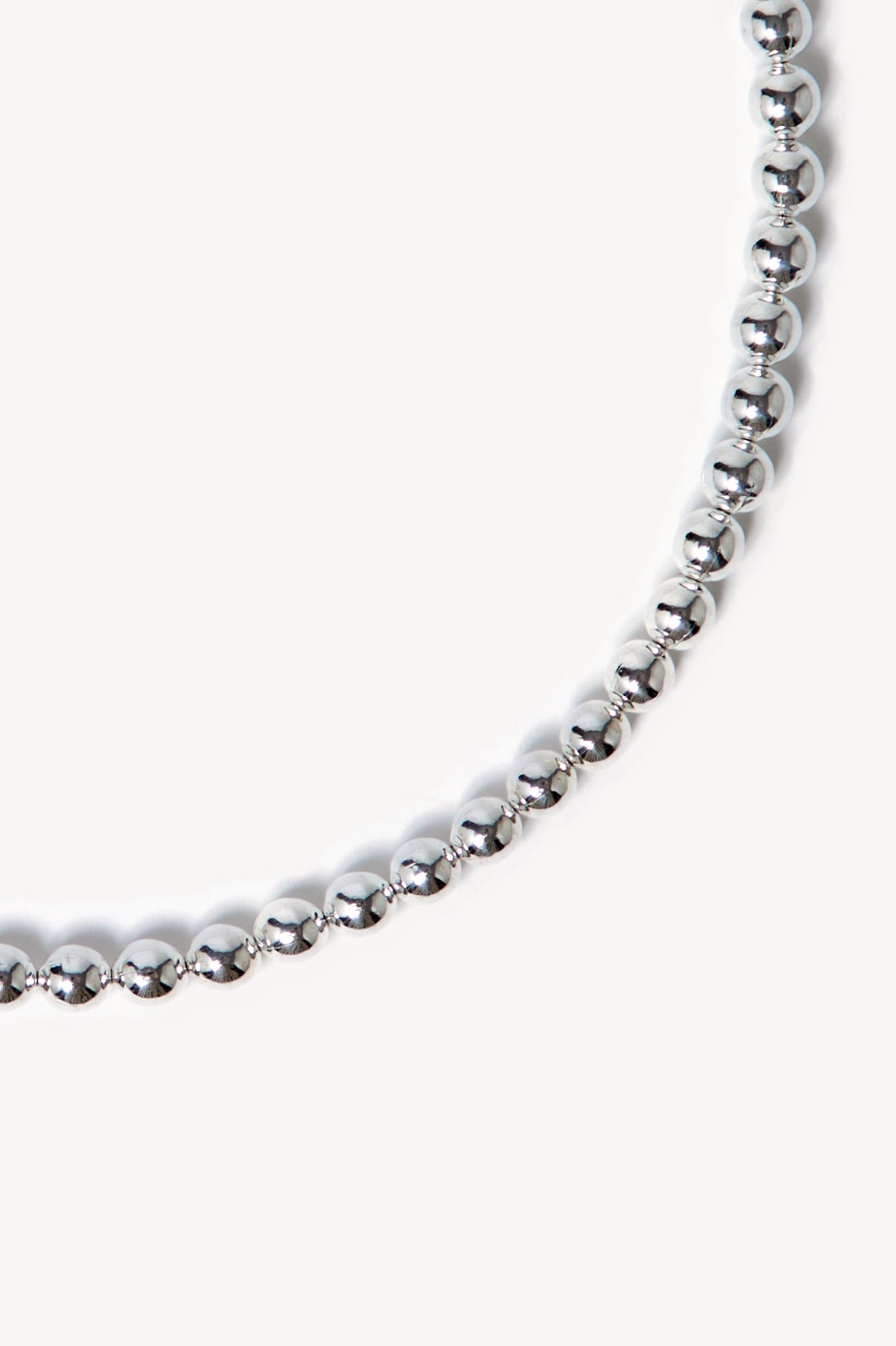 Zoom of a handmade necklace on a neutral background