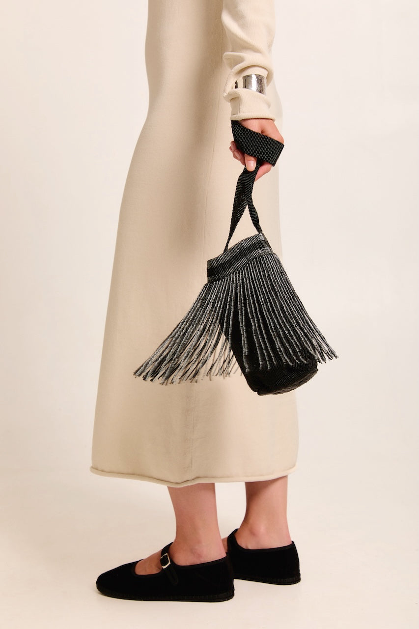 Model holding a Betsá Fringe Mochila Bag on a neutral background.