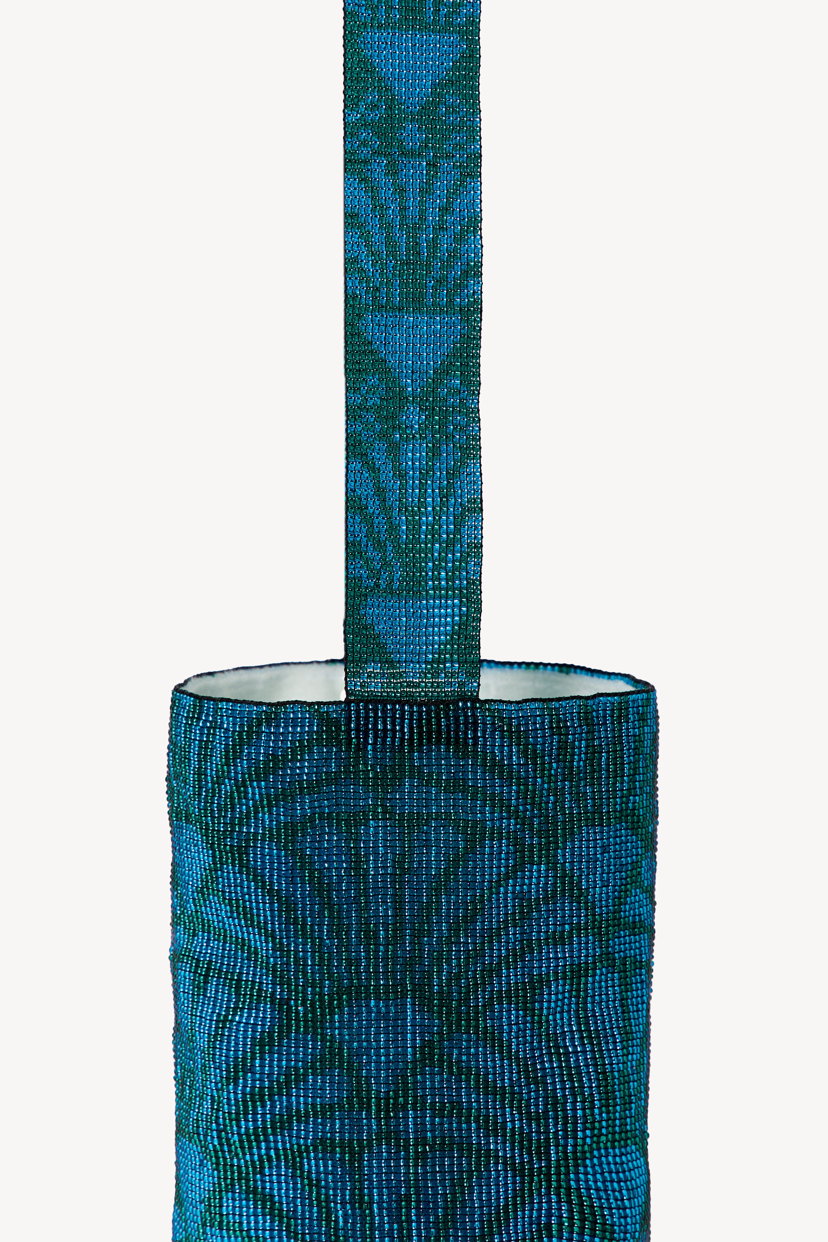 Blue handcrafted bag on a neutral background.