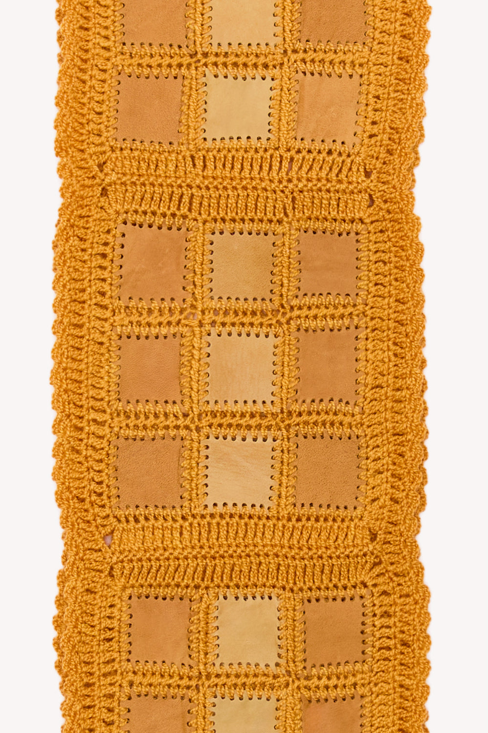 Orange handmade scarf on a neutral background