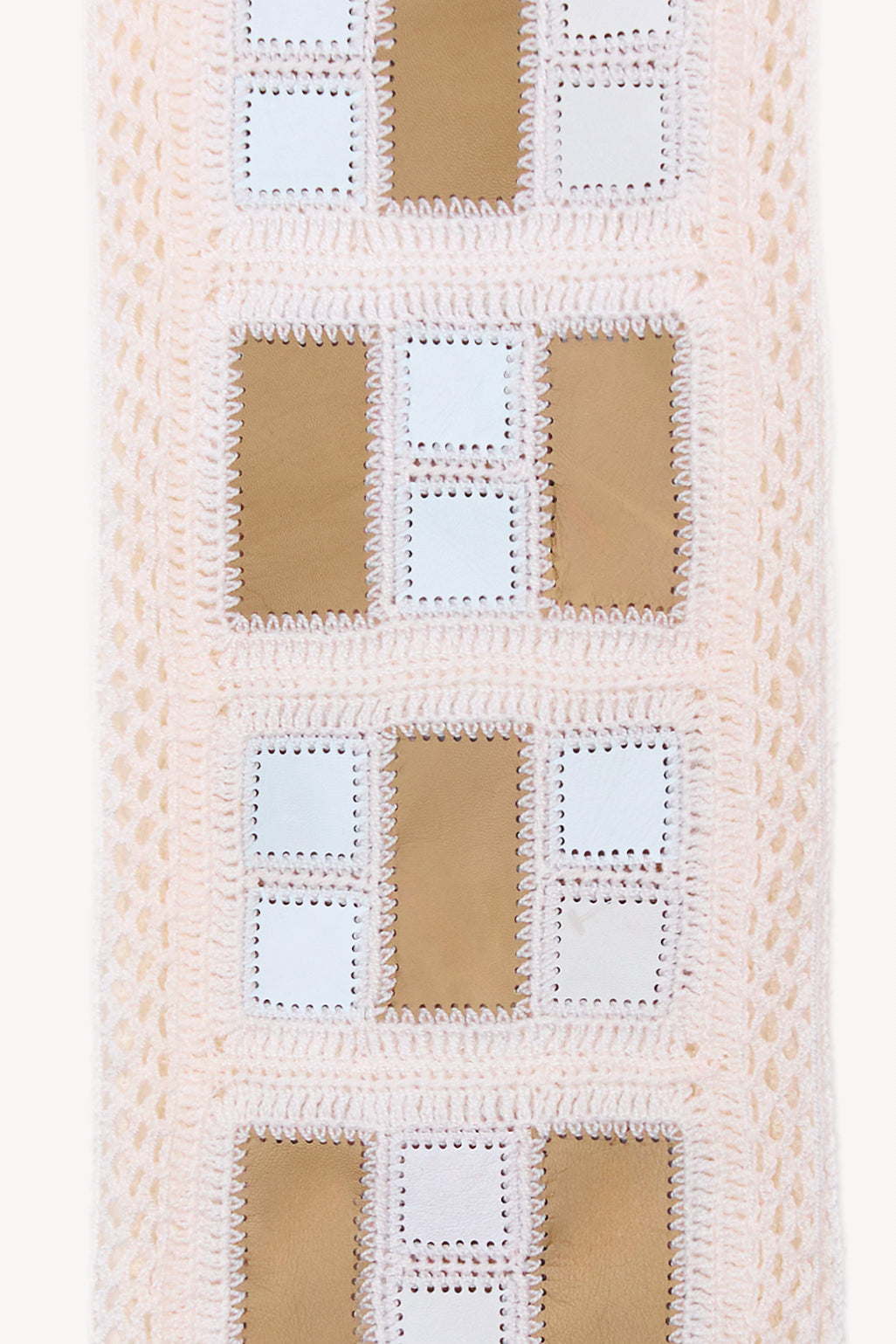 White handmade scarf on a neutral background