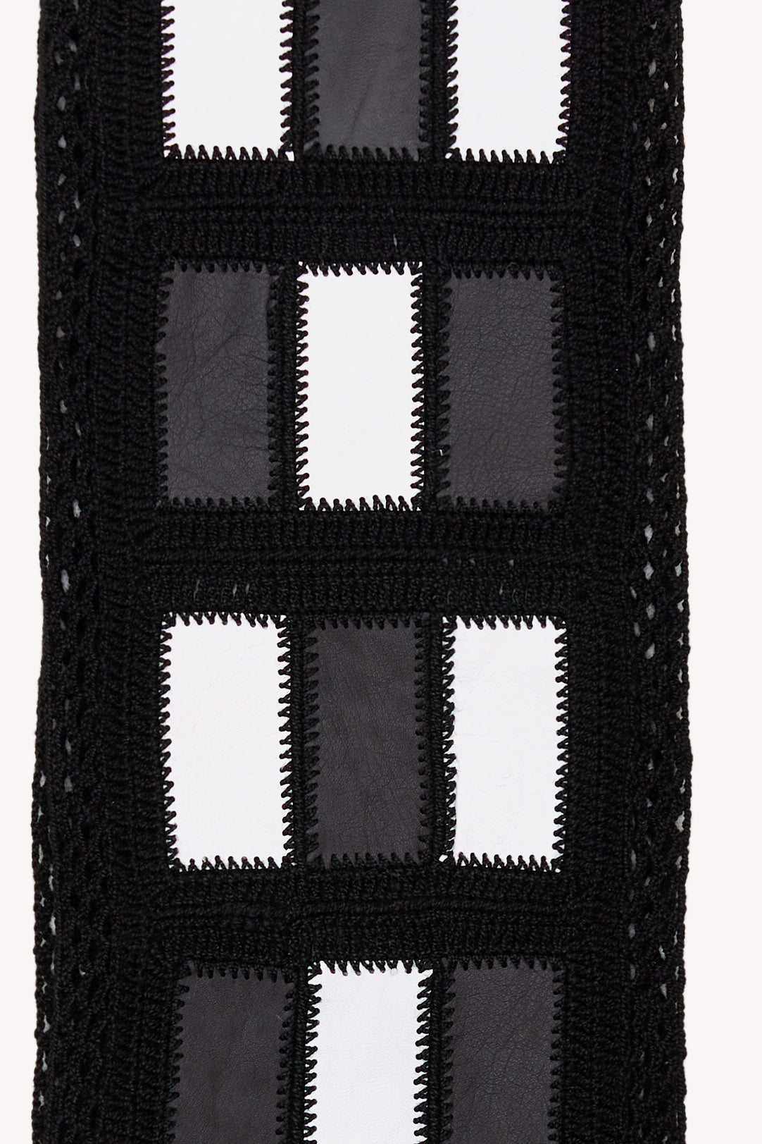 Black and white handmade scarf on a neutral background