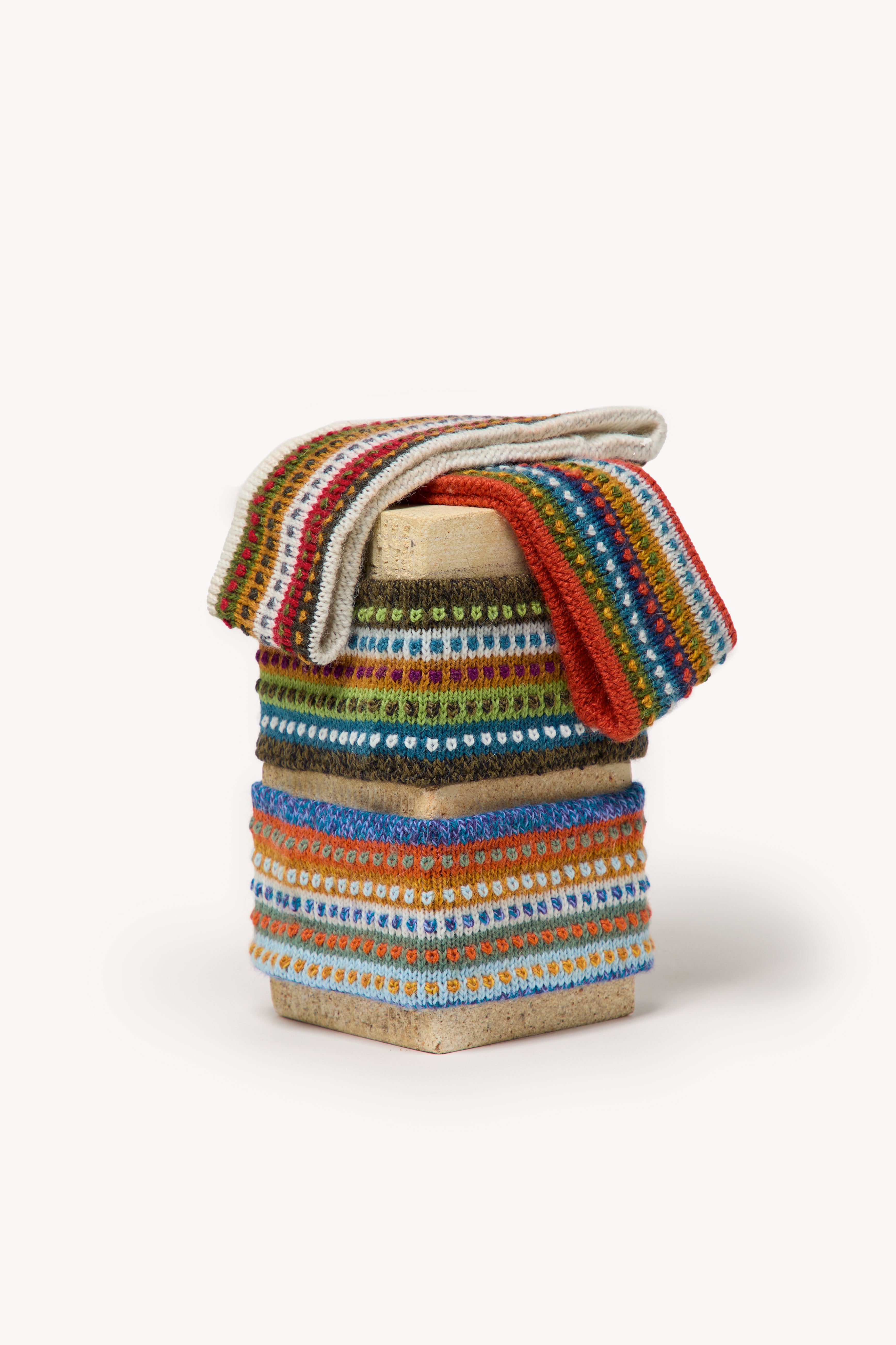 Handmade multicolor headbands displayed on a neutral background