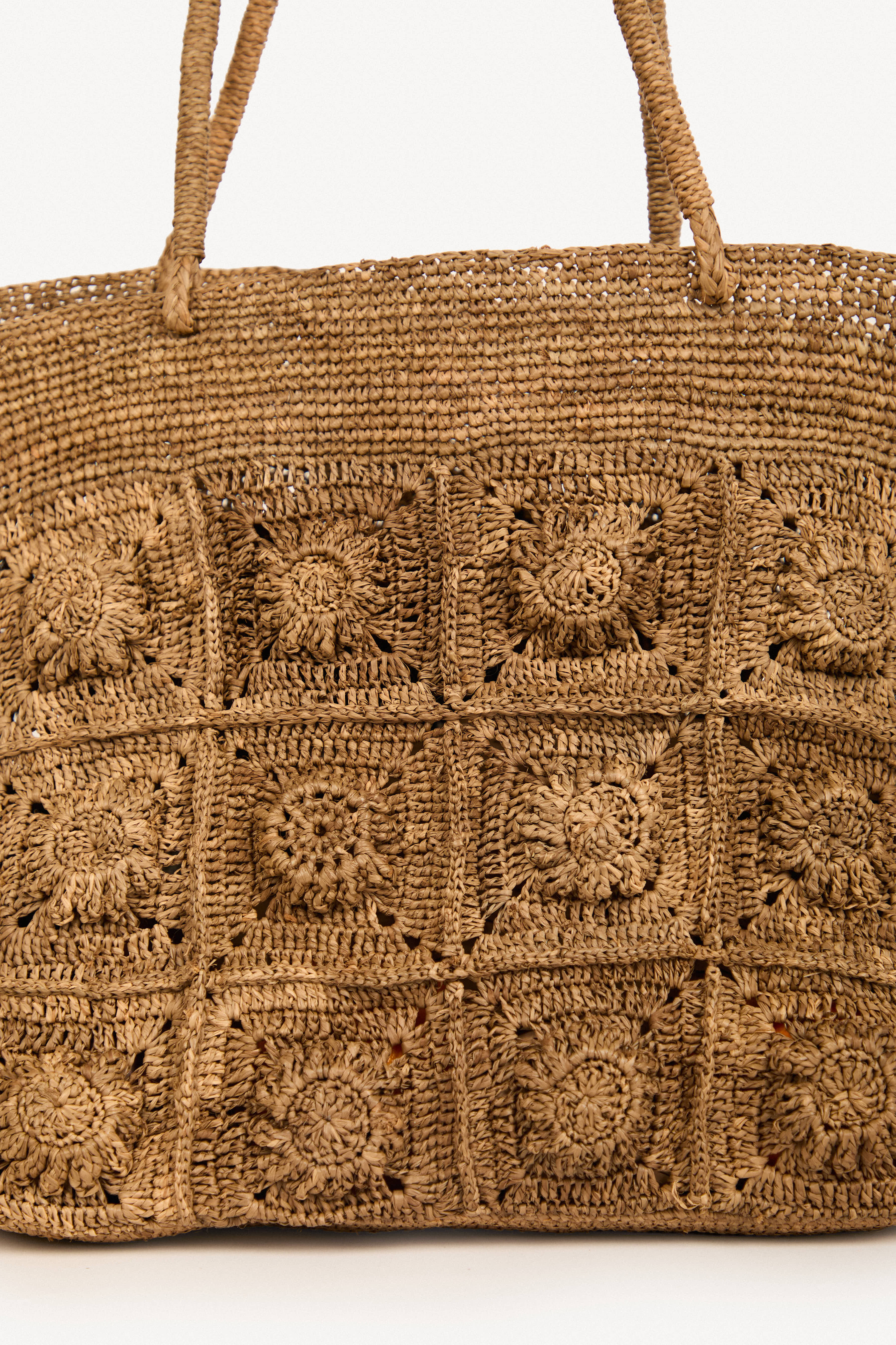 Textured raffia tote bag with floral woven pattern, handmade in Madagascar