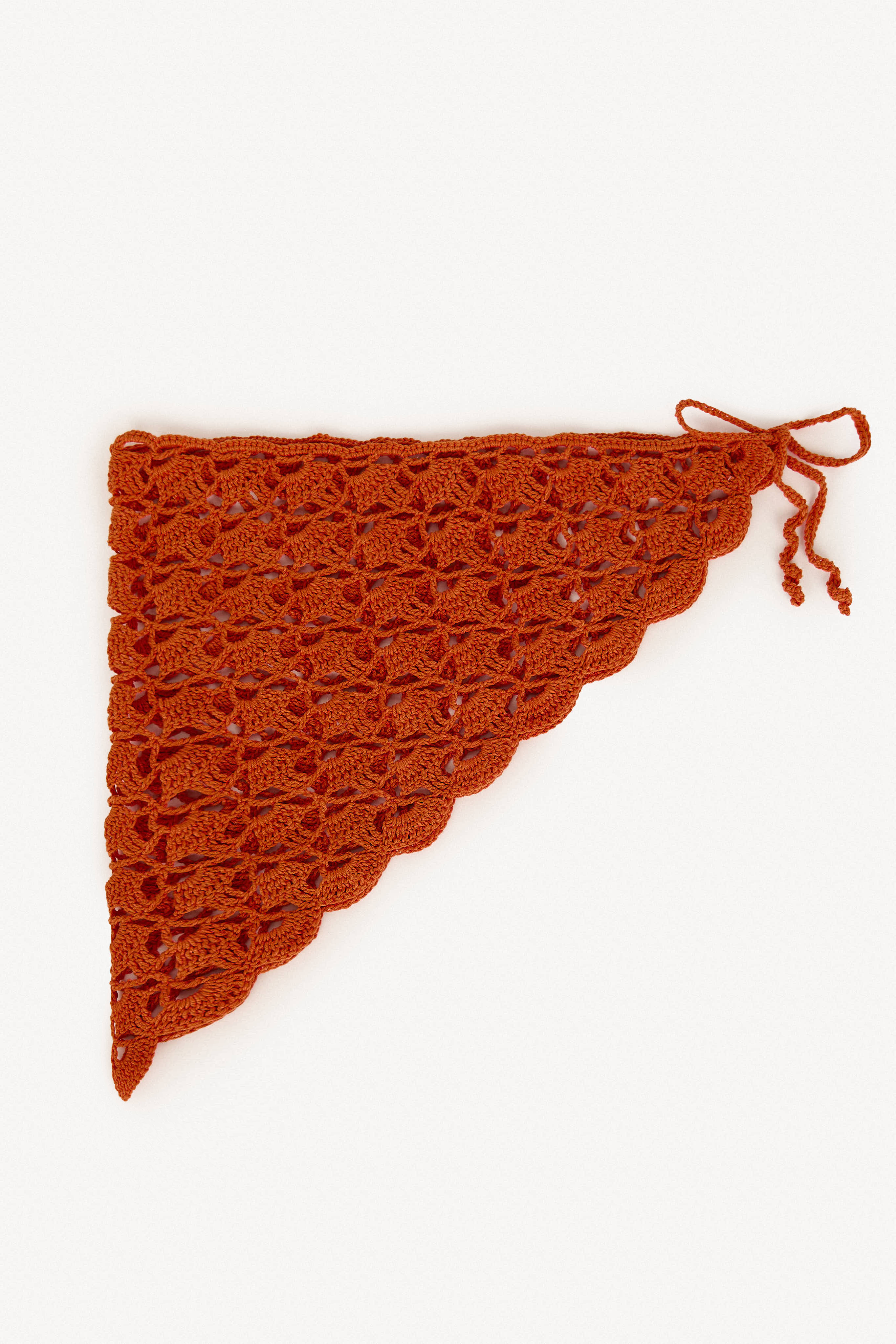 Hand-crocheted cotton hip wrap in terracotta, lightweight pareo handmade in Ecuador.